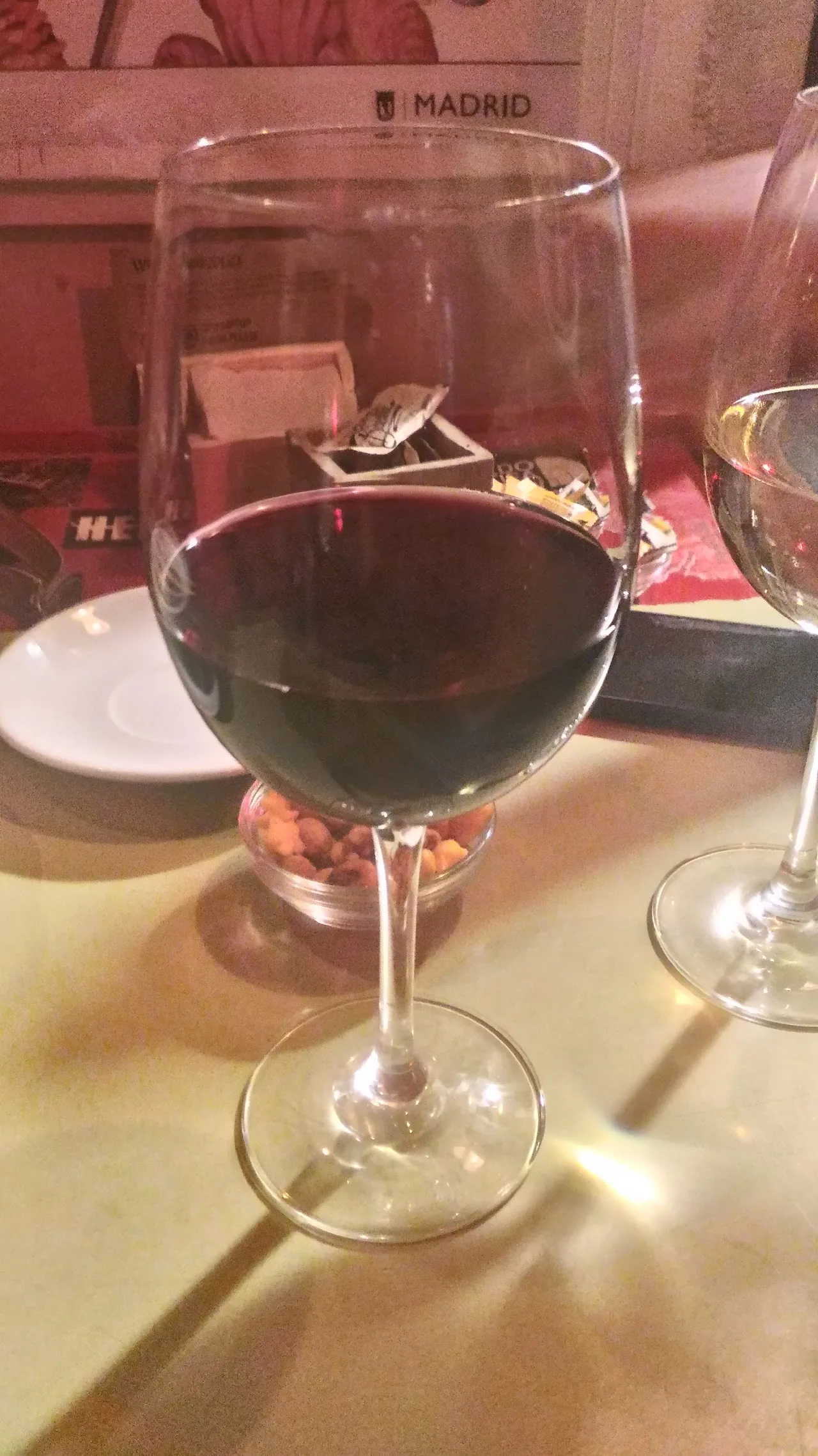 A glass of red wine on a restaurant table