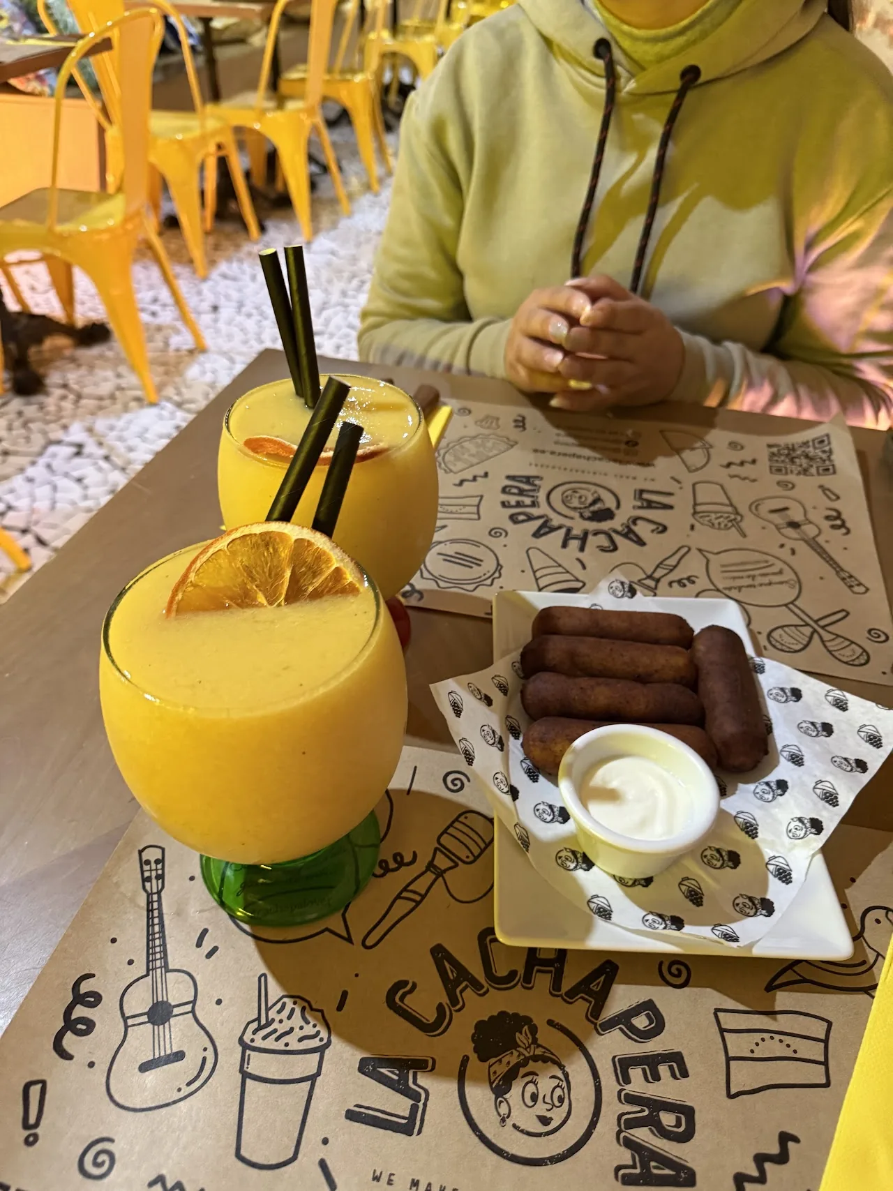 Two frozen fruit drinks and a chocolate dessert on a cafe table