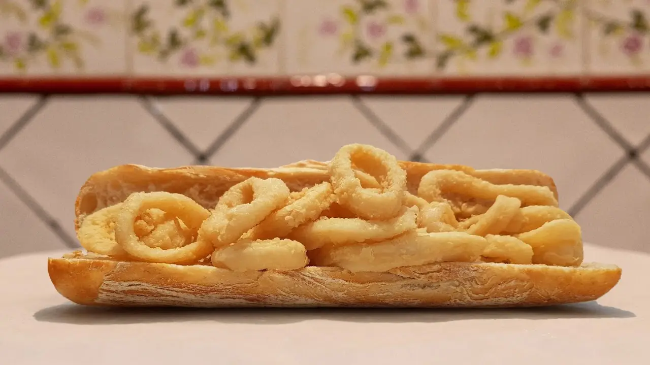 A bocadillo de calamares, fried squid rings piled in a long crusty roll