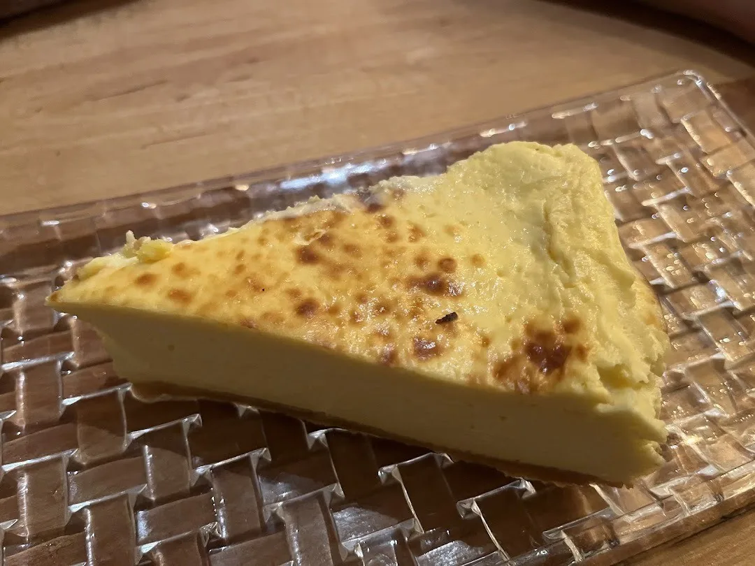A golden baked wedge on a glass plate