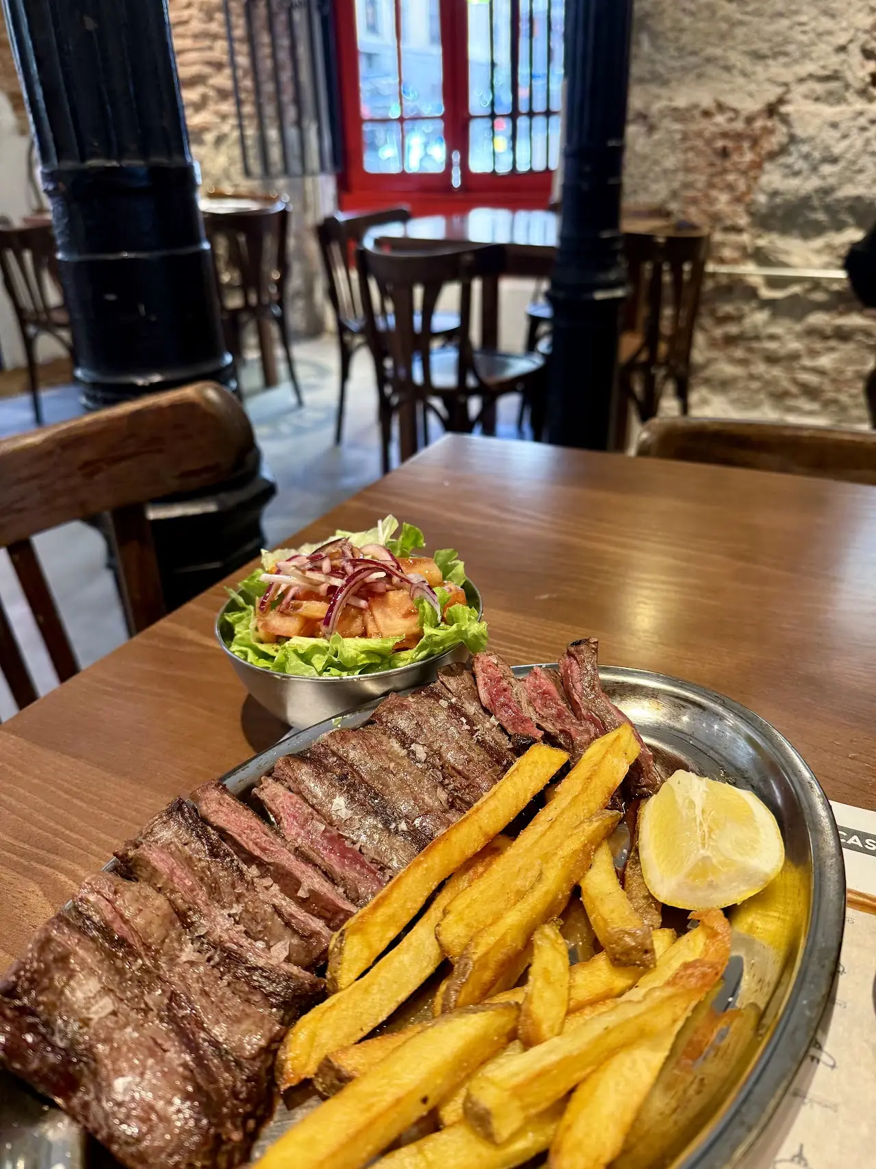 Grilled skirt steak with chips, lemon and a side salad.