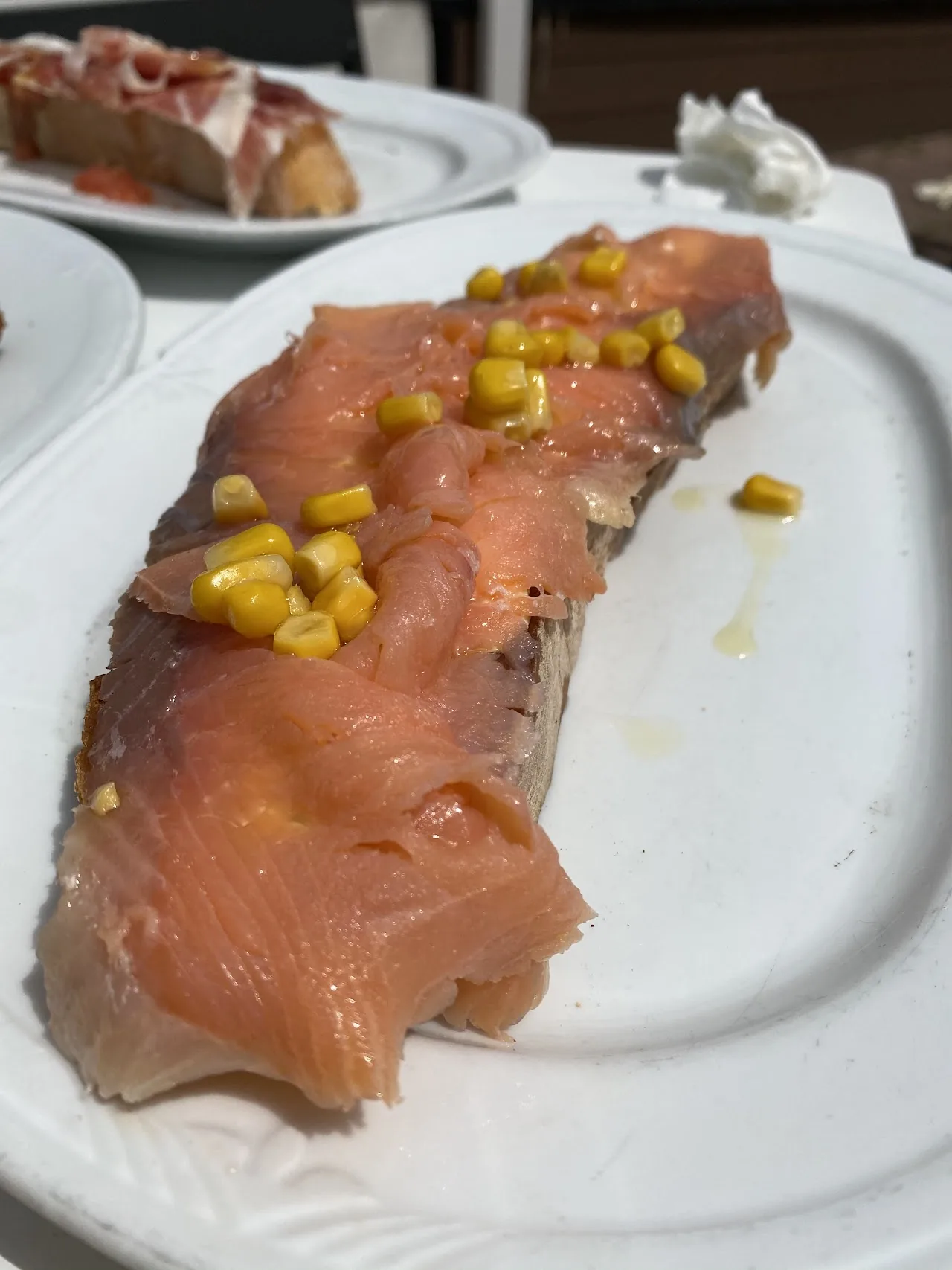 A plate of smoked salmon with sweet corn