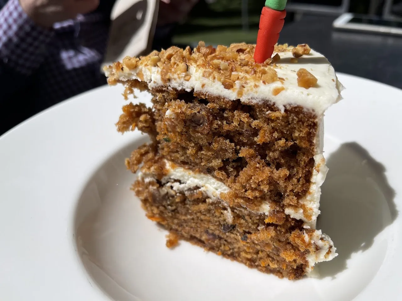 A slice of carrot cake with cream cheese frosting
