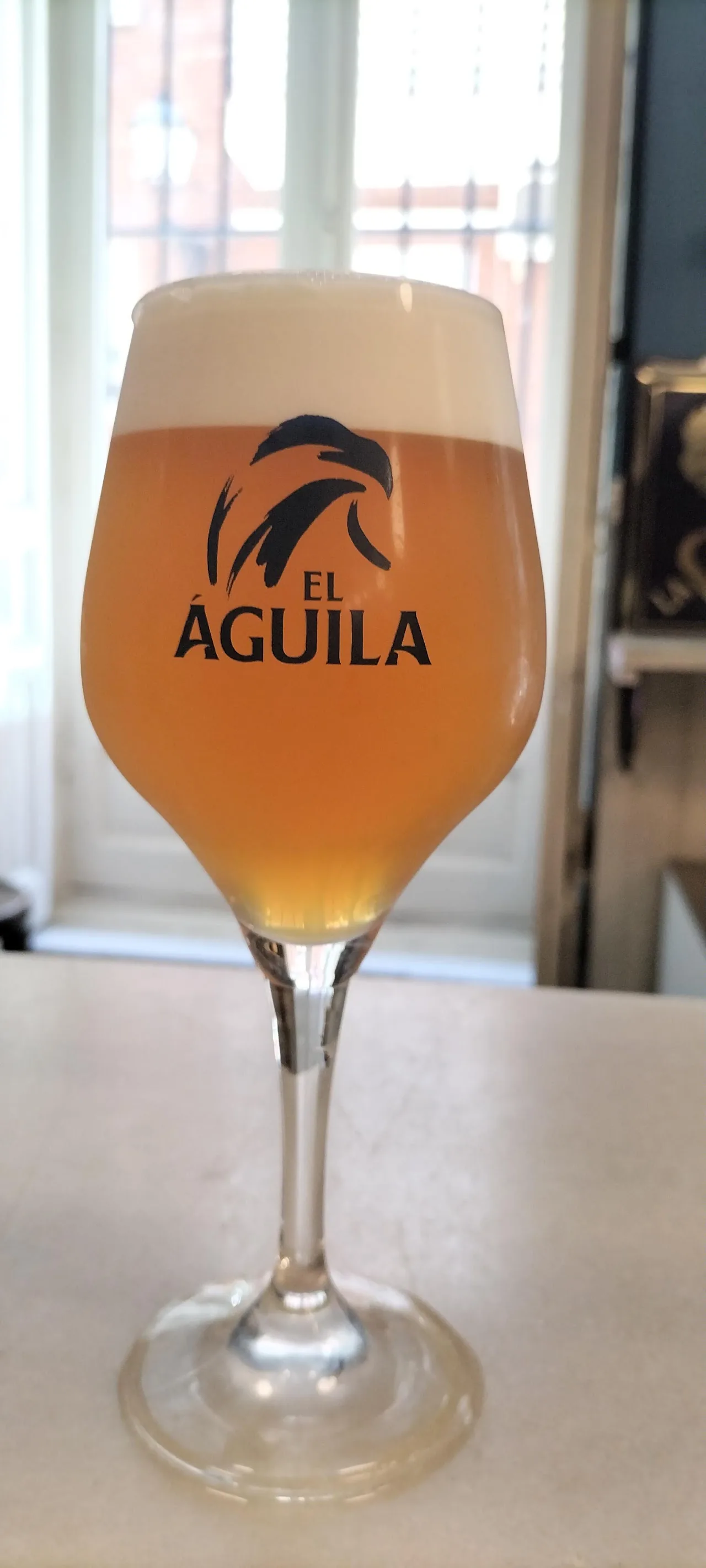 A glass of Aguila draft beer
