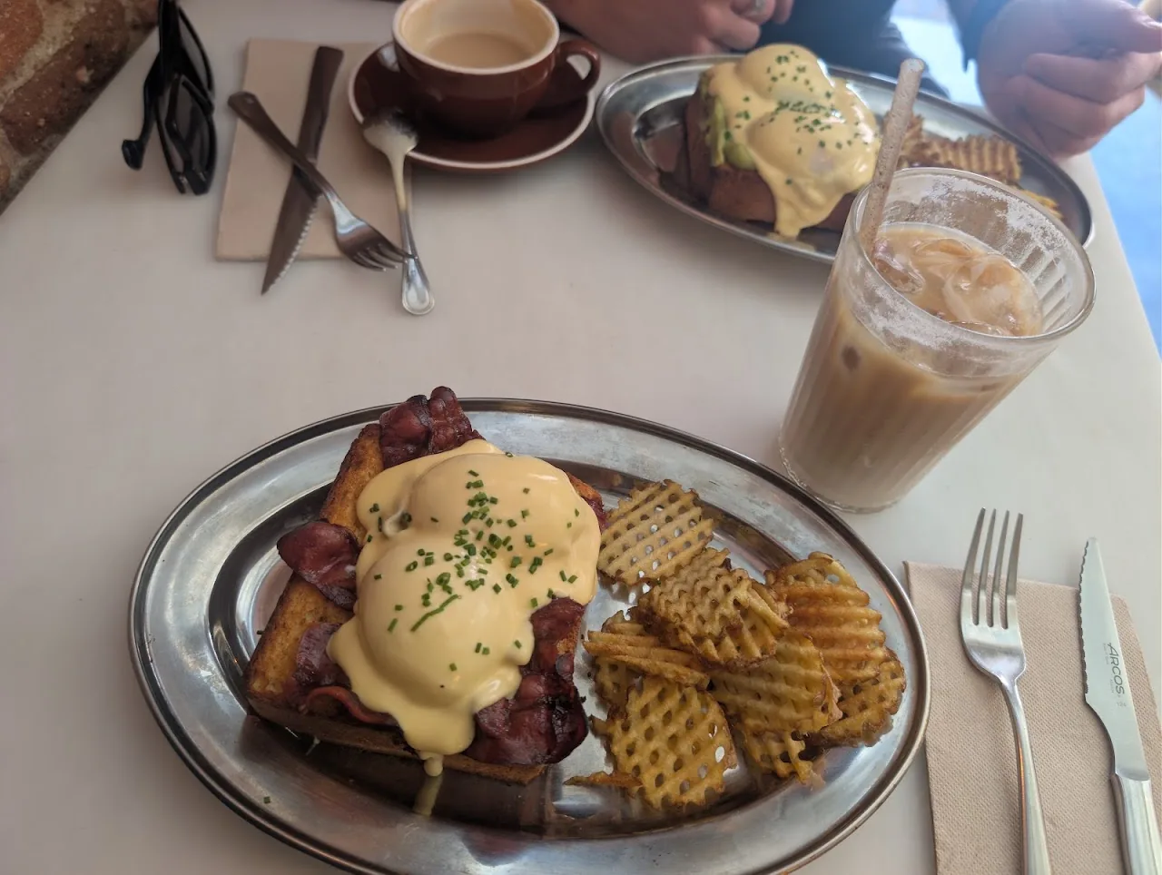 Eggs Benedict with a side of waffles, coffee, and iced coffee