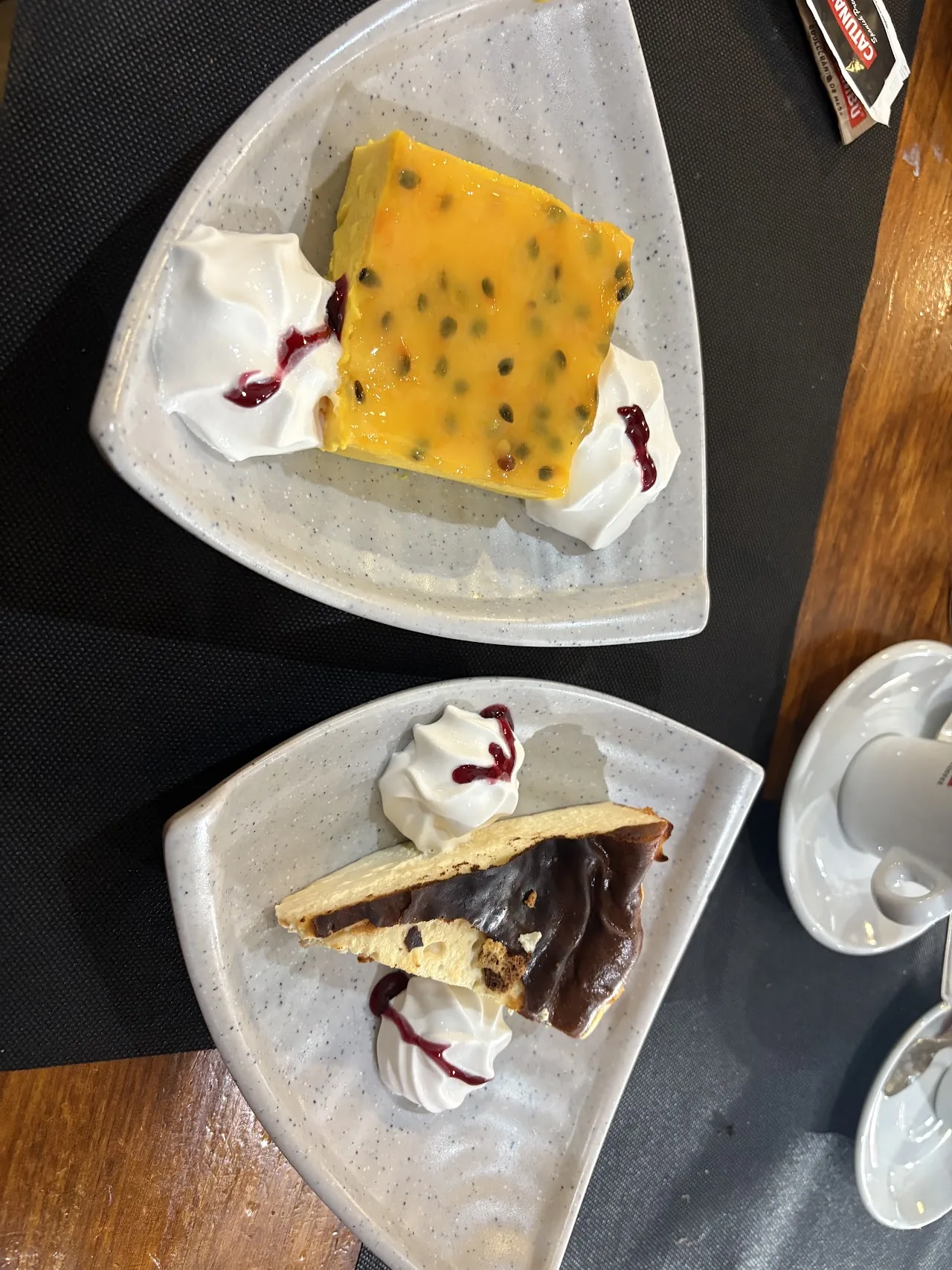 A slice of passion fruit cheesecake with berry sauce