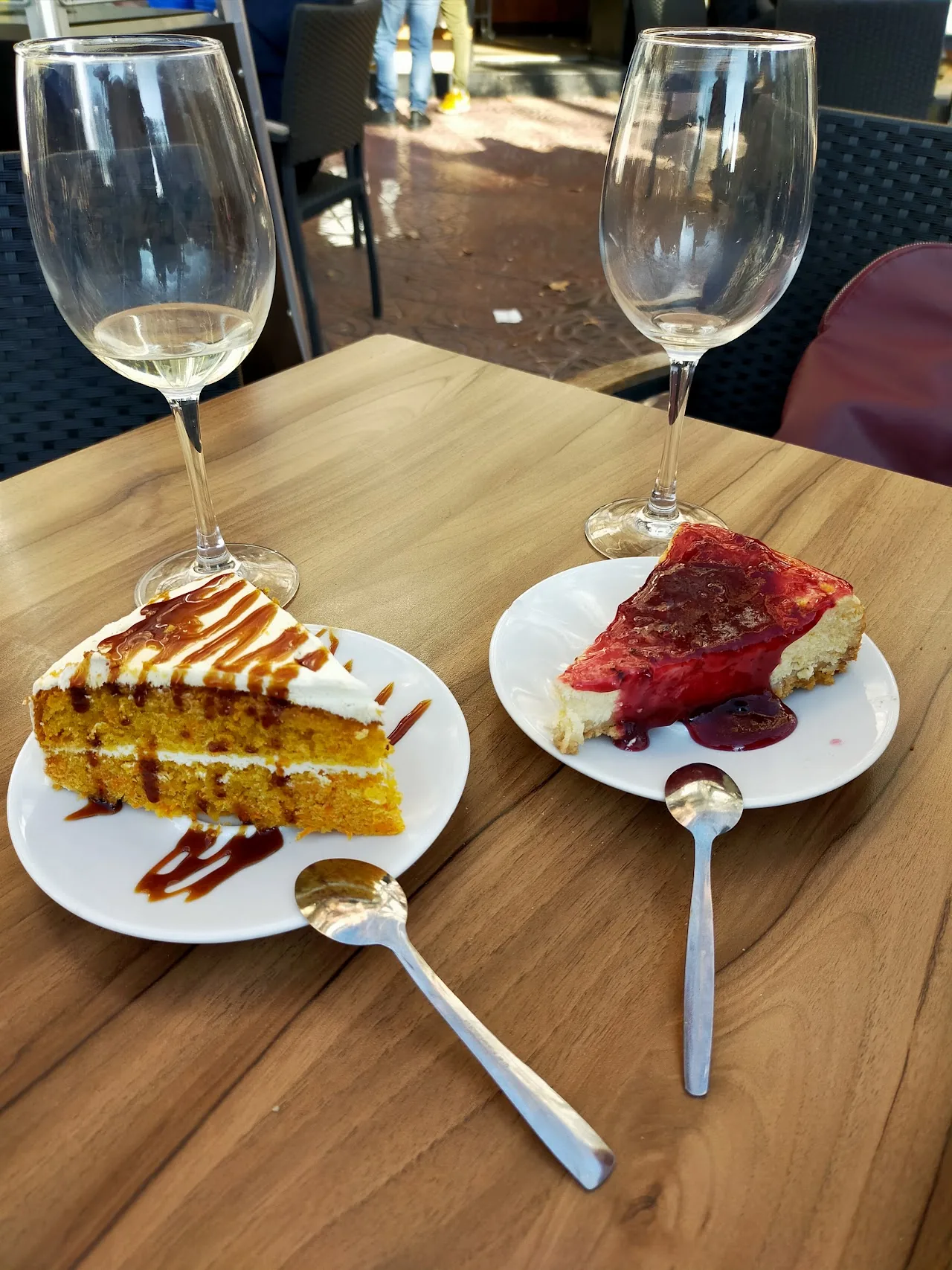 Two dessert slices, a layer cake and a red velvet cake, on a cafe table