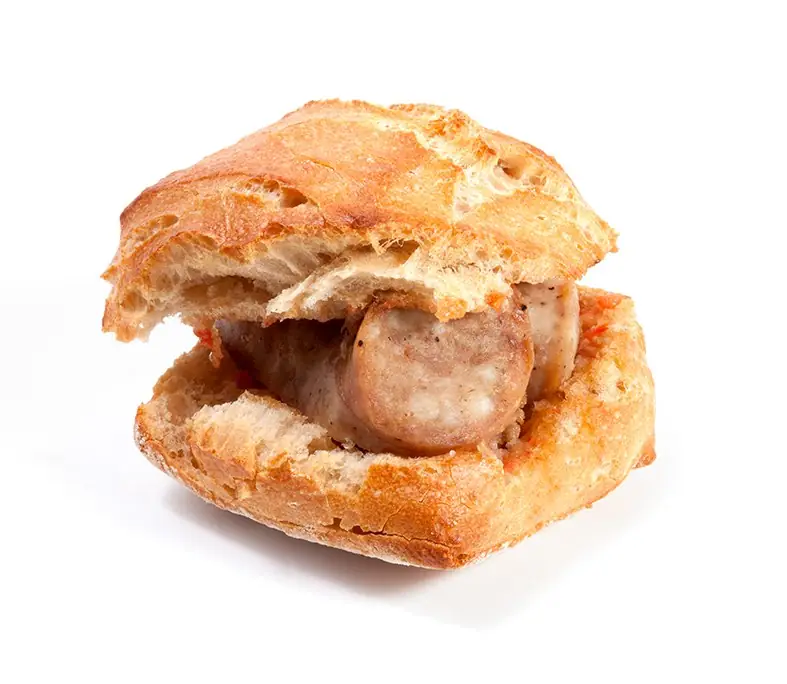 Bread roll filled with slices of grilled sausage