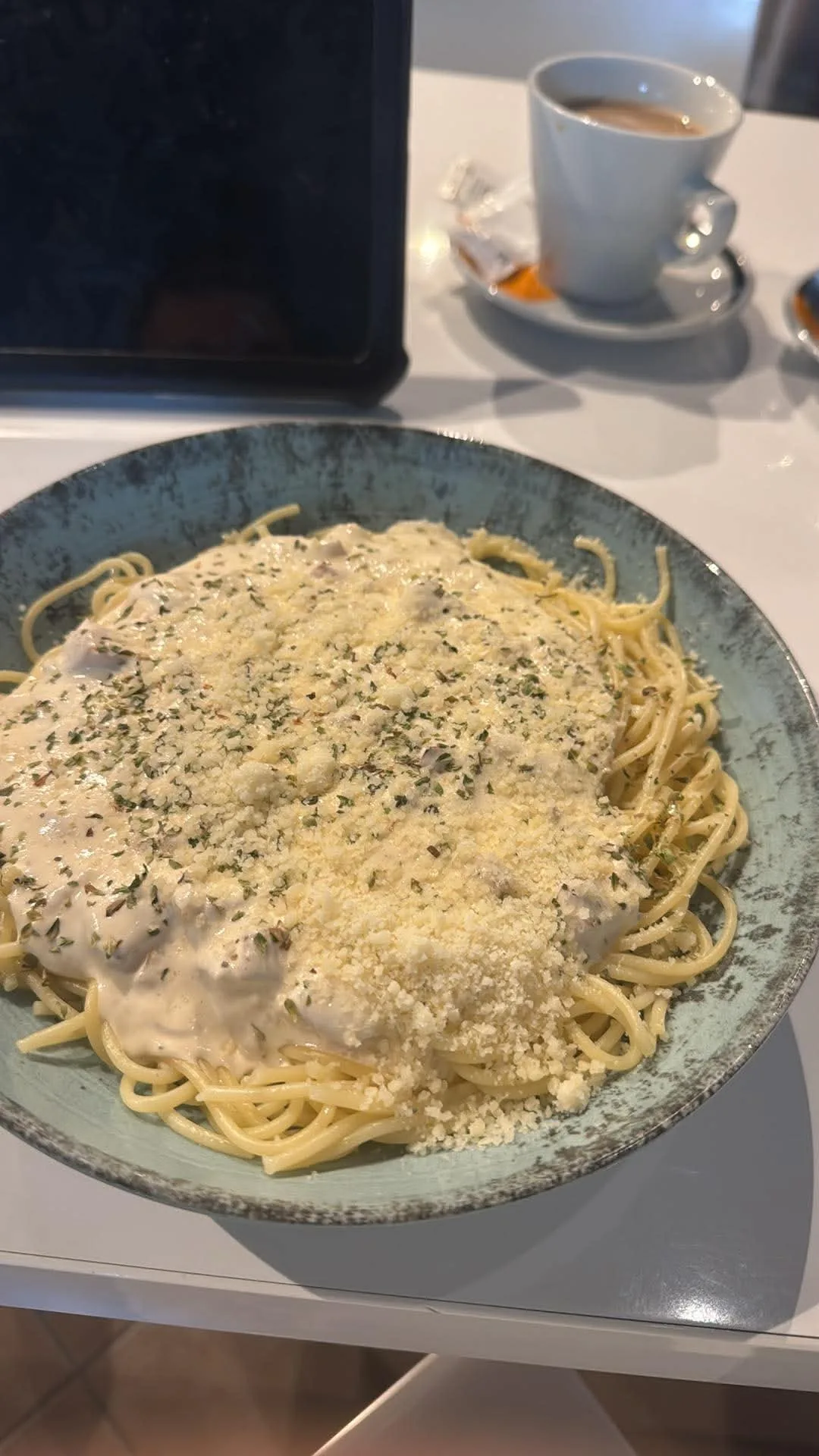 A plate of creamy pasta topped with grated cheese