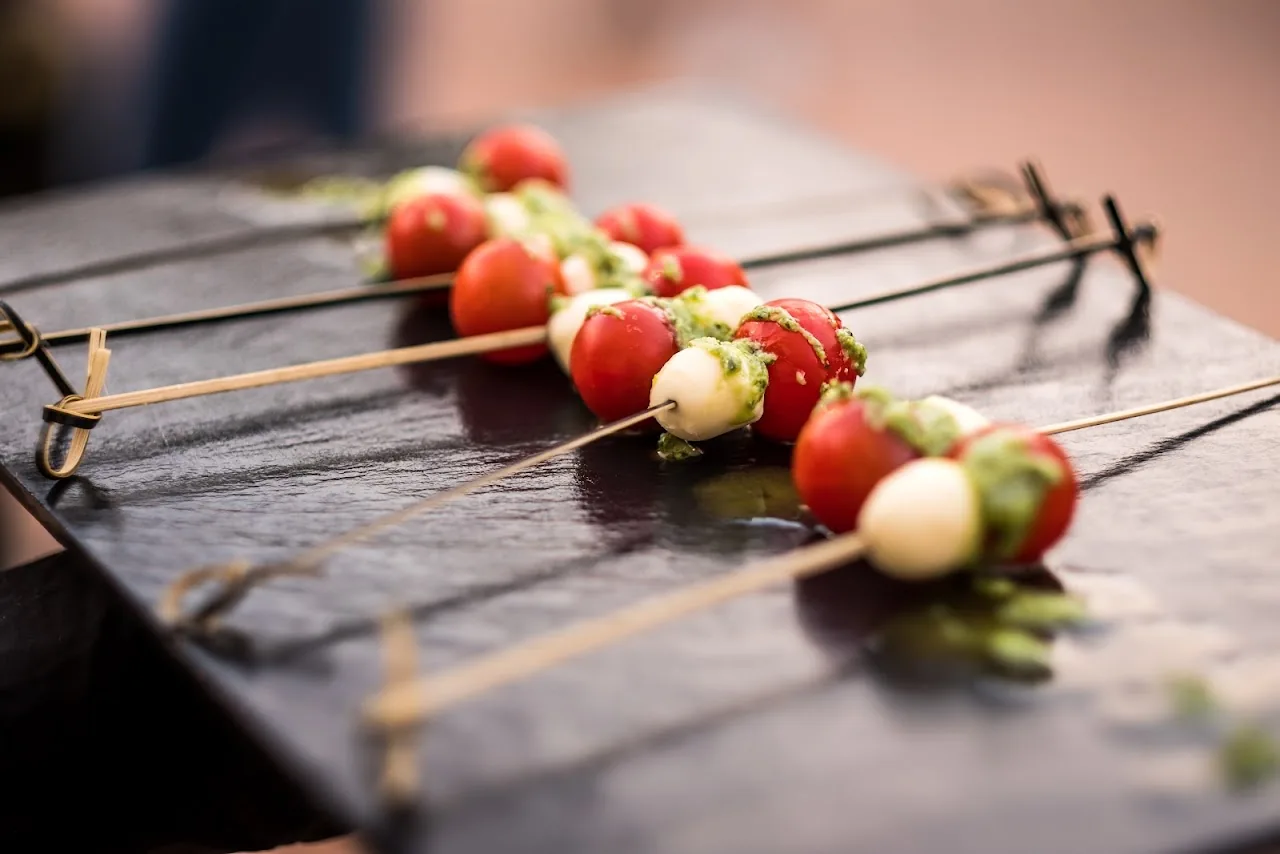 Skewers of cherry tomato and mozzarella balls with basil