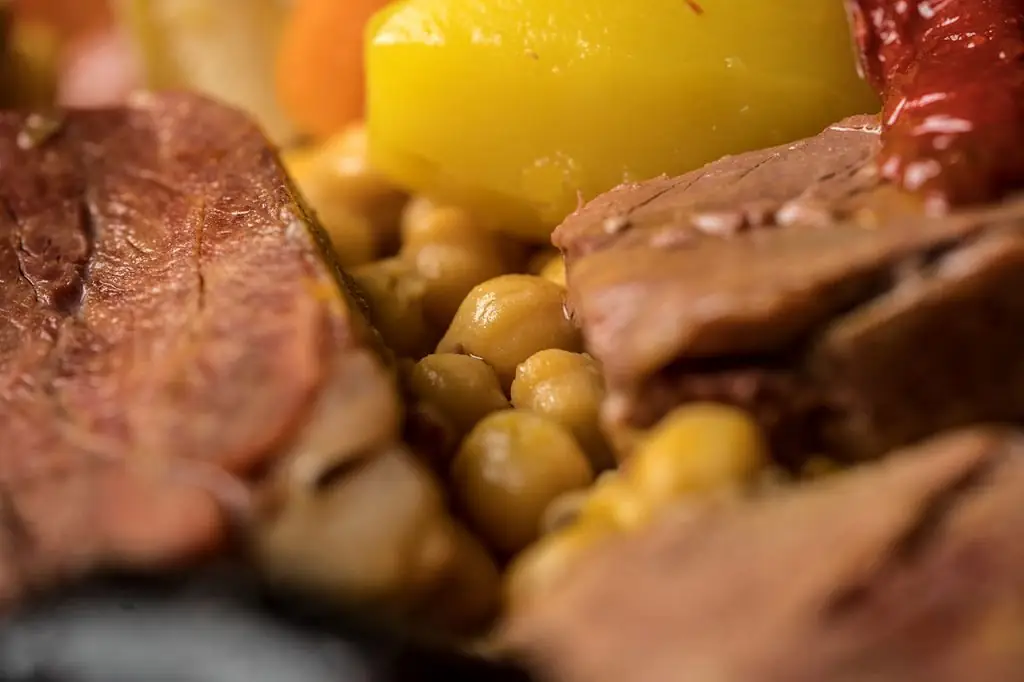 Close-up of cocido madrileno with chickpeas, boiled beef, potato, carrot and chorizo