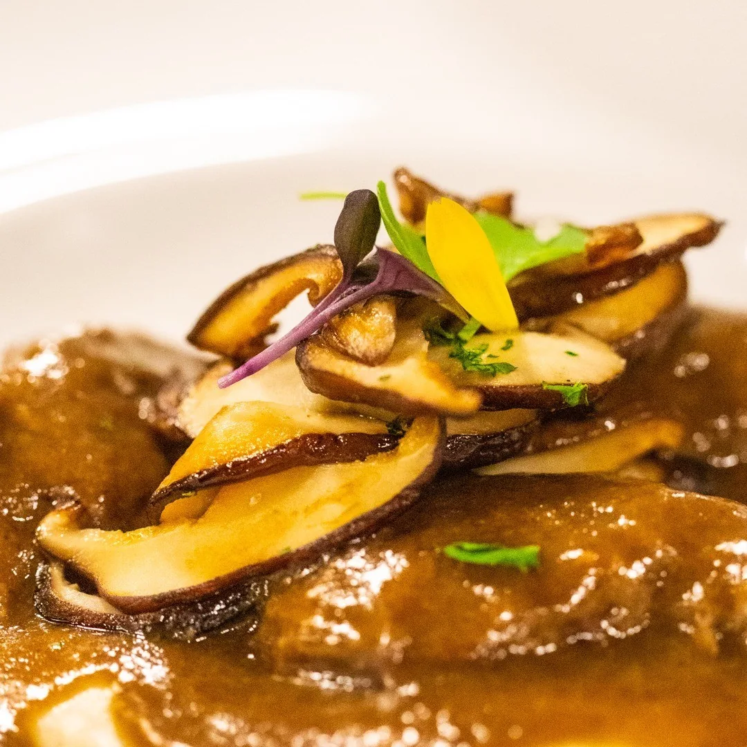 Sliced mushrooms in a brown sauce