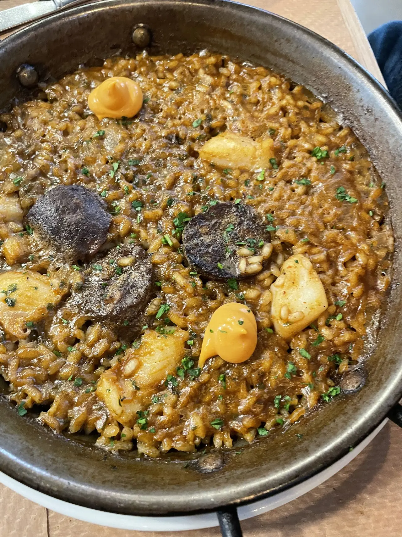 A pan of rice with mushrooms and mussels.