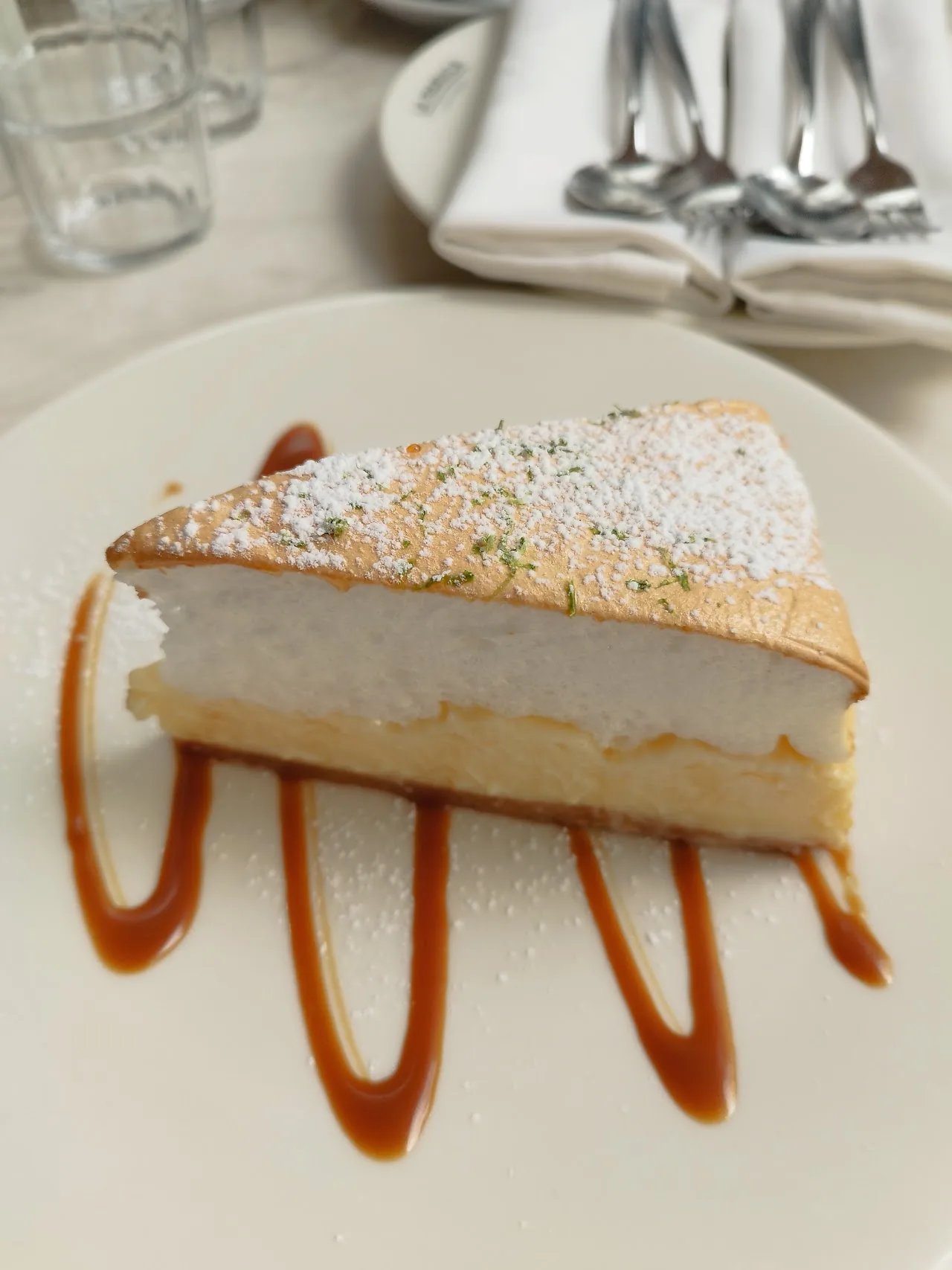A slice of lemon meringue pie with caramel drizzle