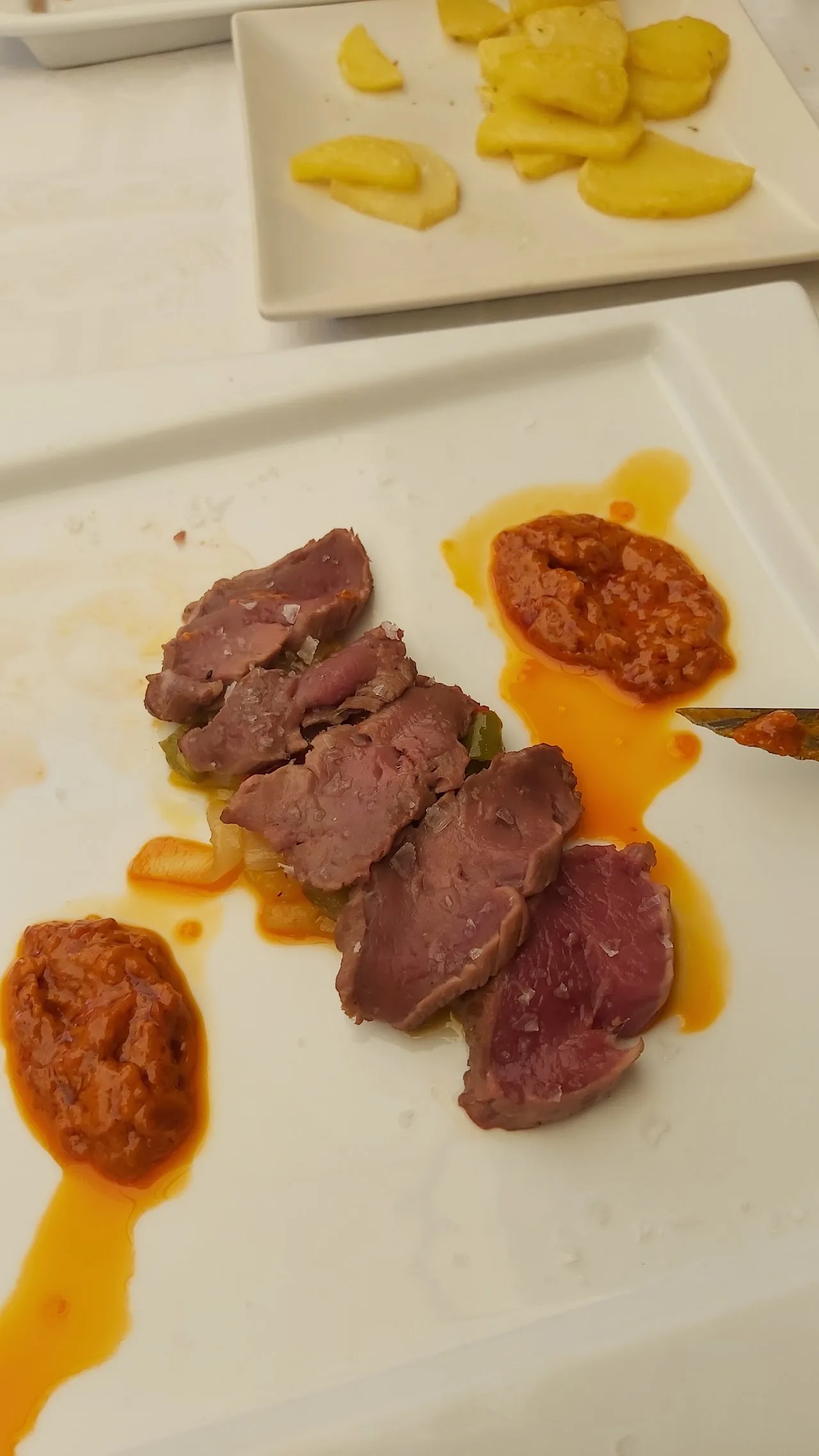 Sliced cured meats arranged on a plate