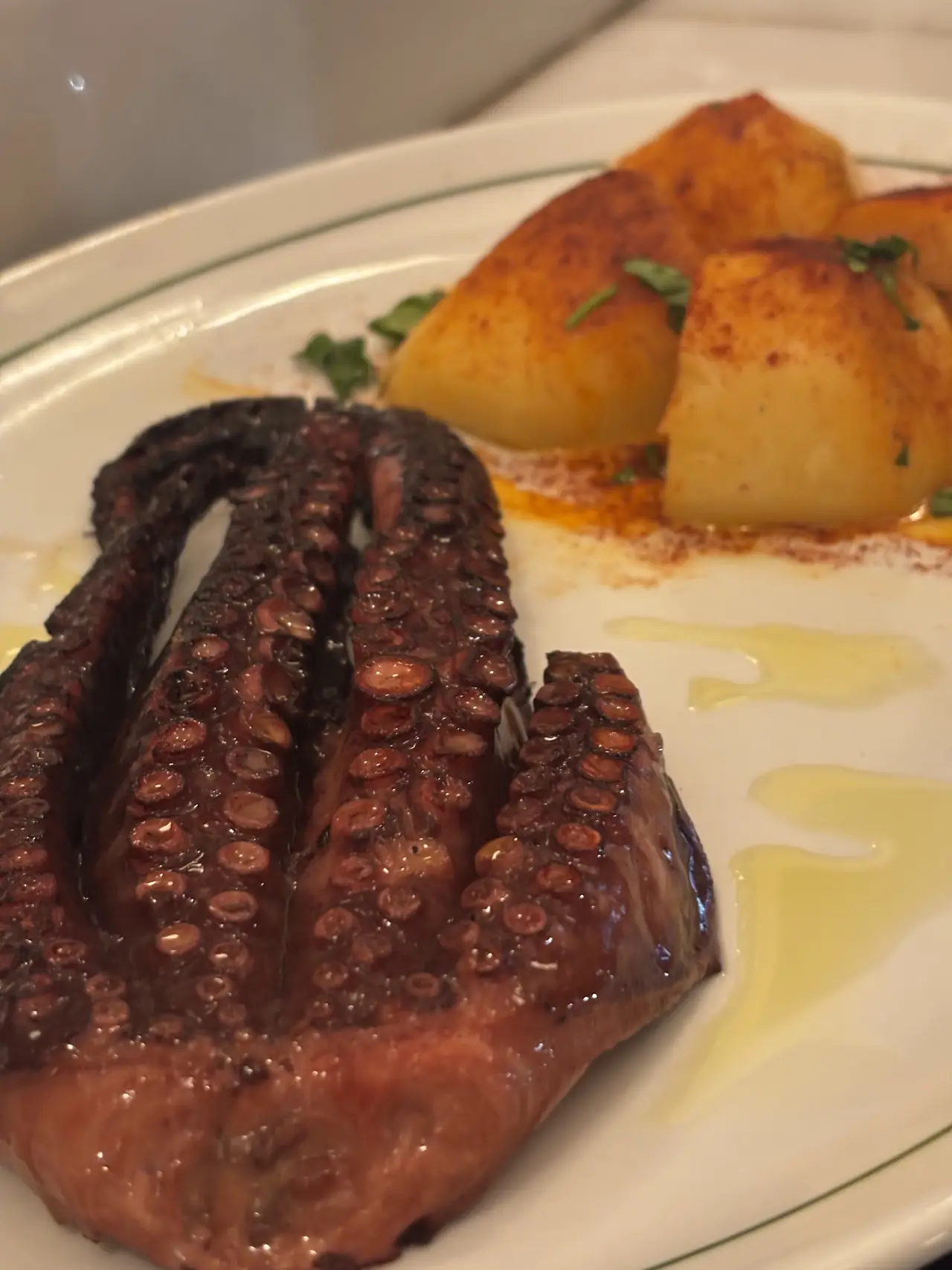Grilled octopus tentacles with paprika-dusted potatoes and olive oil
