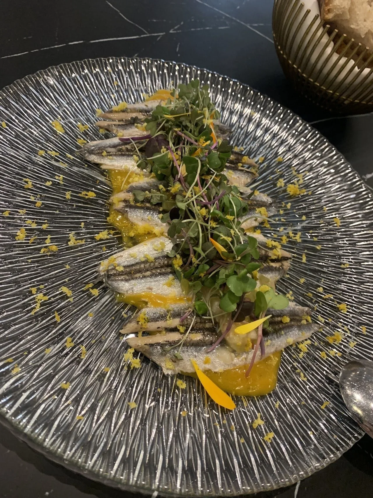 Fillets of fish with herbs on a ridged glass plate