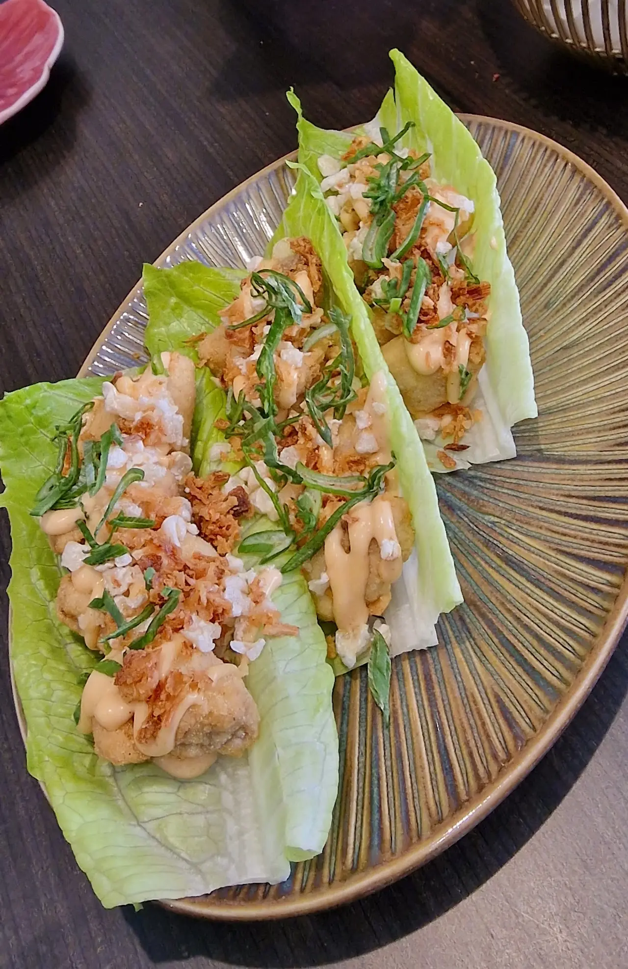 Lettuce cups filled with diced seafood, herbs and a light sauce