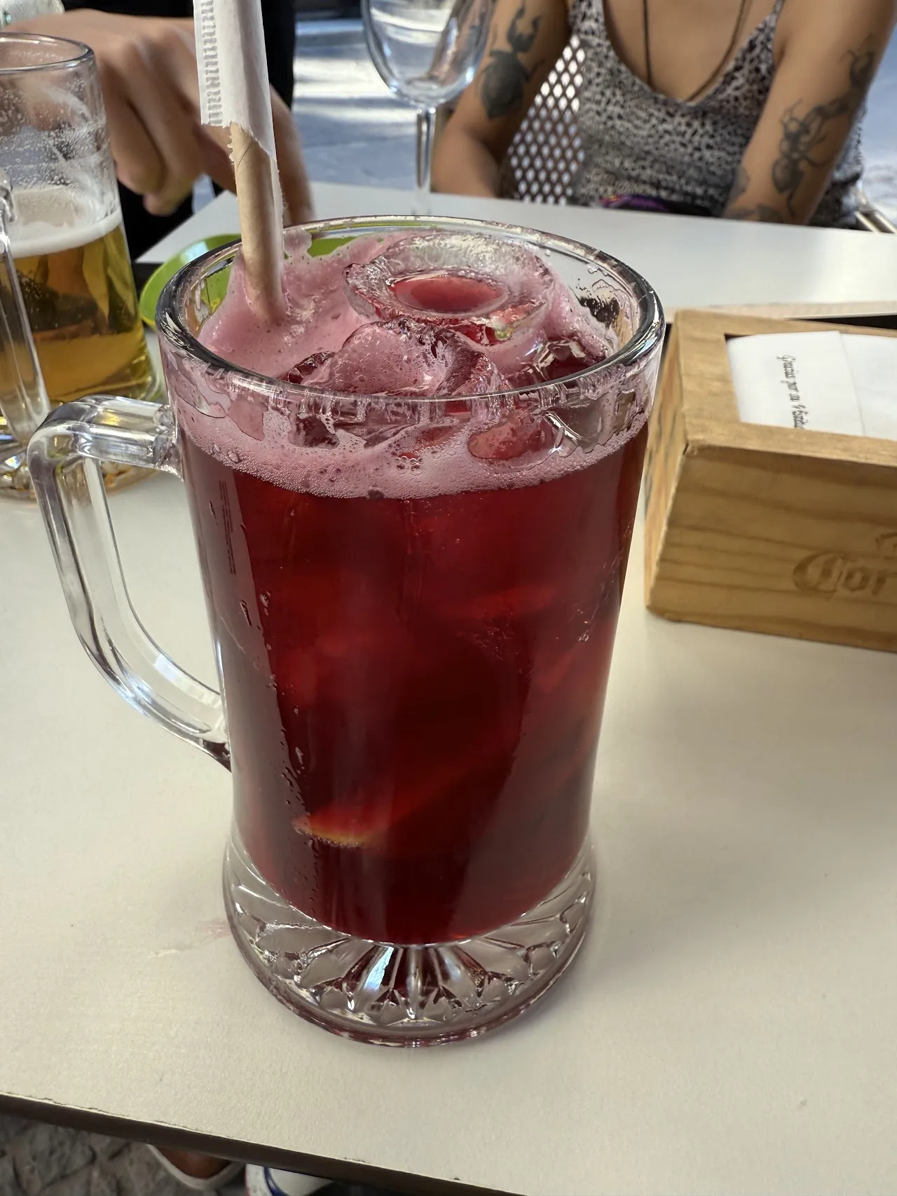 A glass mug of sangria with ice