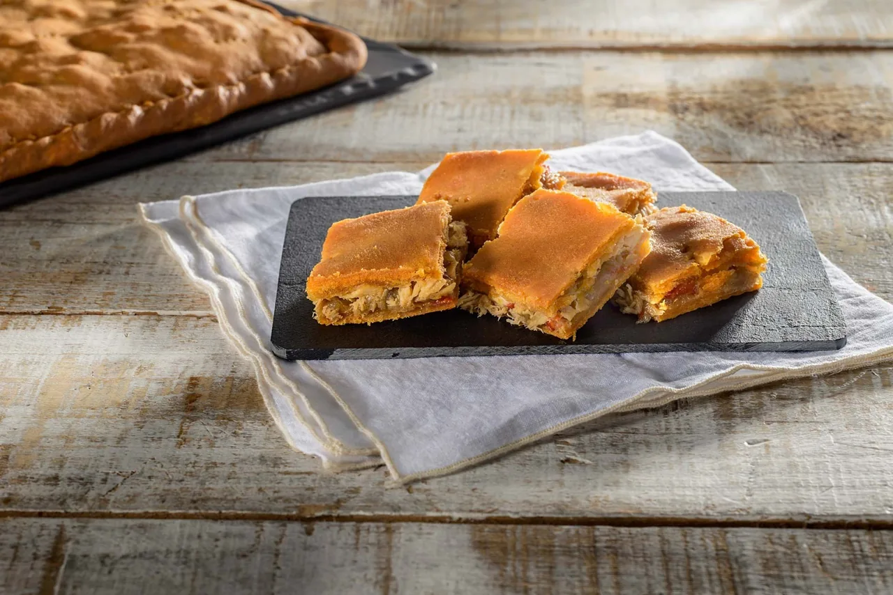 Squares of golden baked pie on a slate board