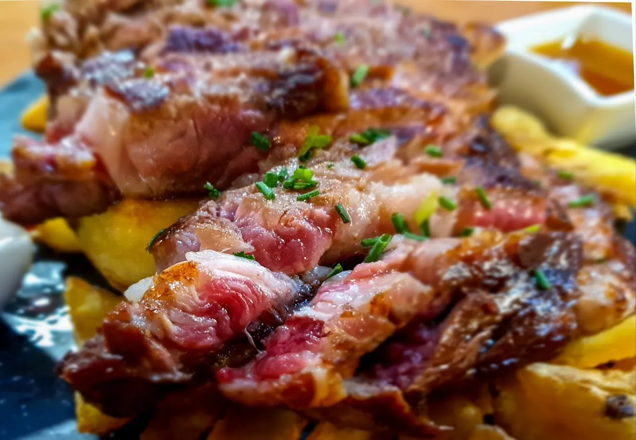Crispy bacon and fries topped with a fried egg drizzle