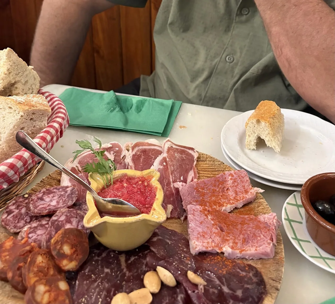 A charcuterie board with cured meats, cheese and bread