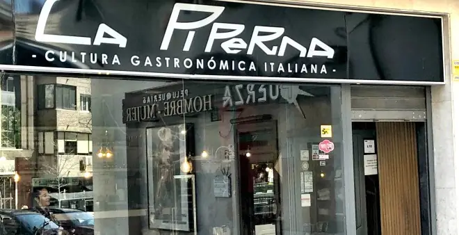 Exterior storefront of La Piperna with black sign reading Cultura Gastronomica Italiana