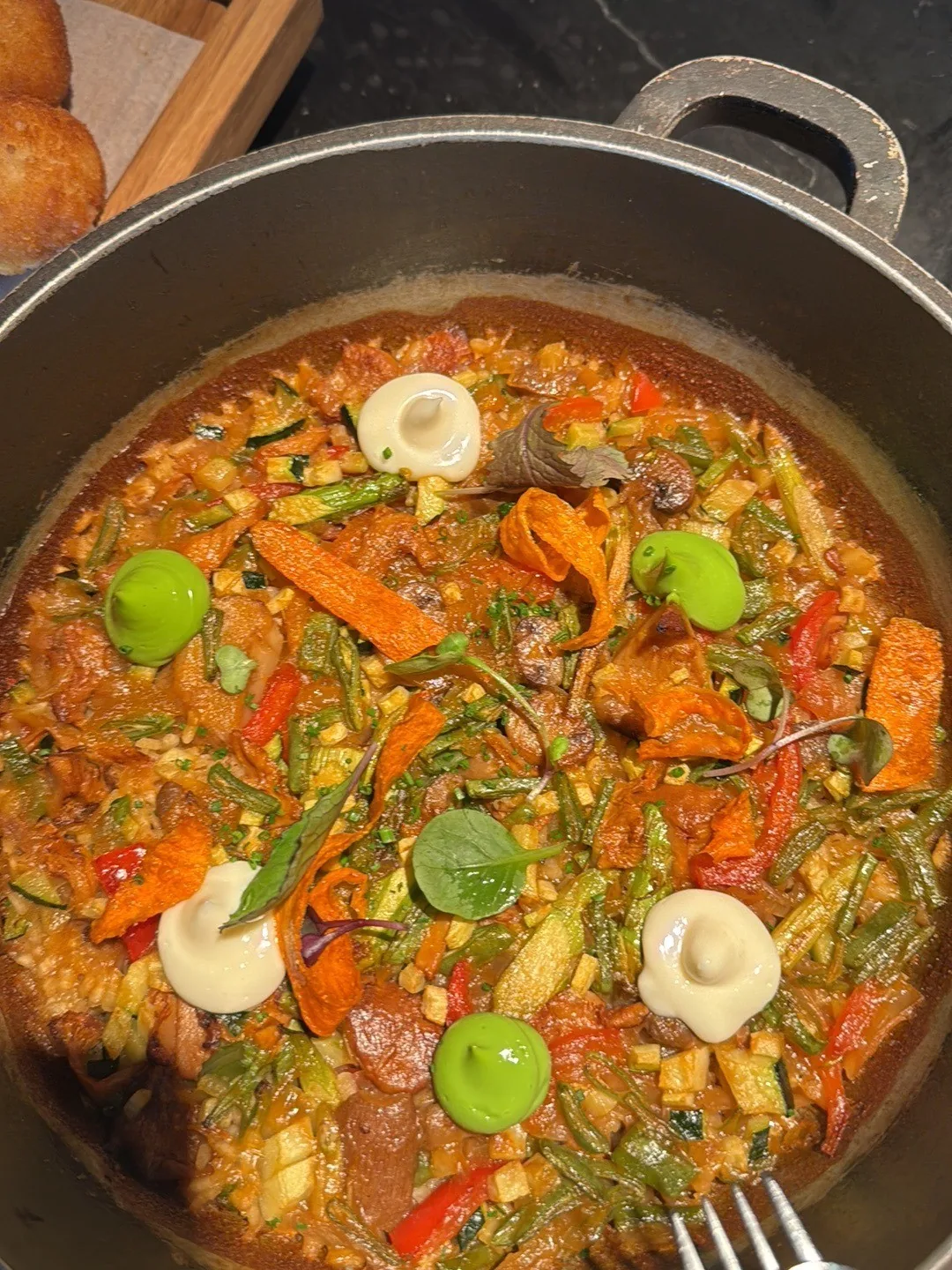 A paella with vegetables in a wide pan