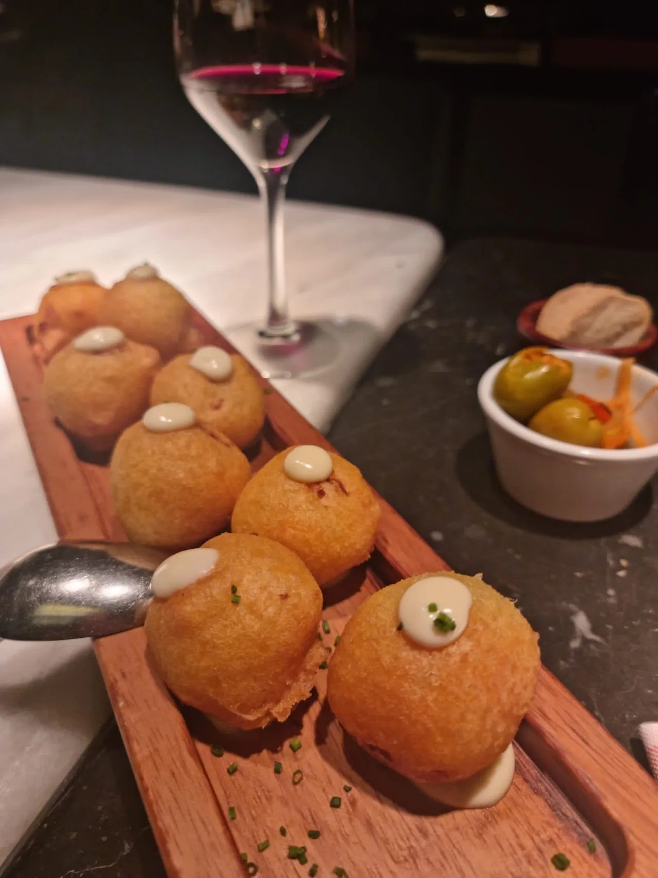 Golden fried croquettes on a wooden board