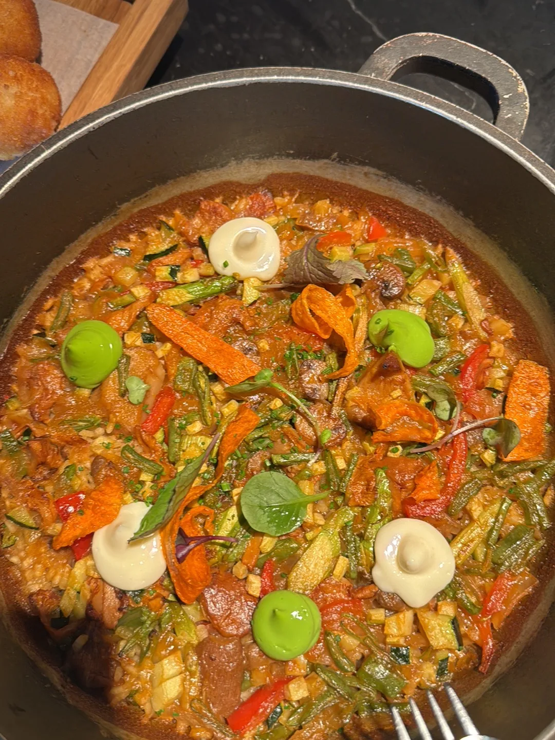 A pan of vegetable and seafood stew with chorizo and mussels
