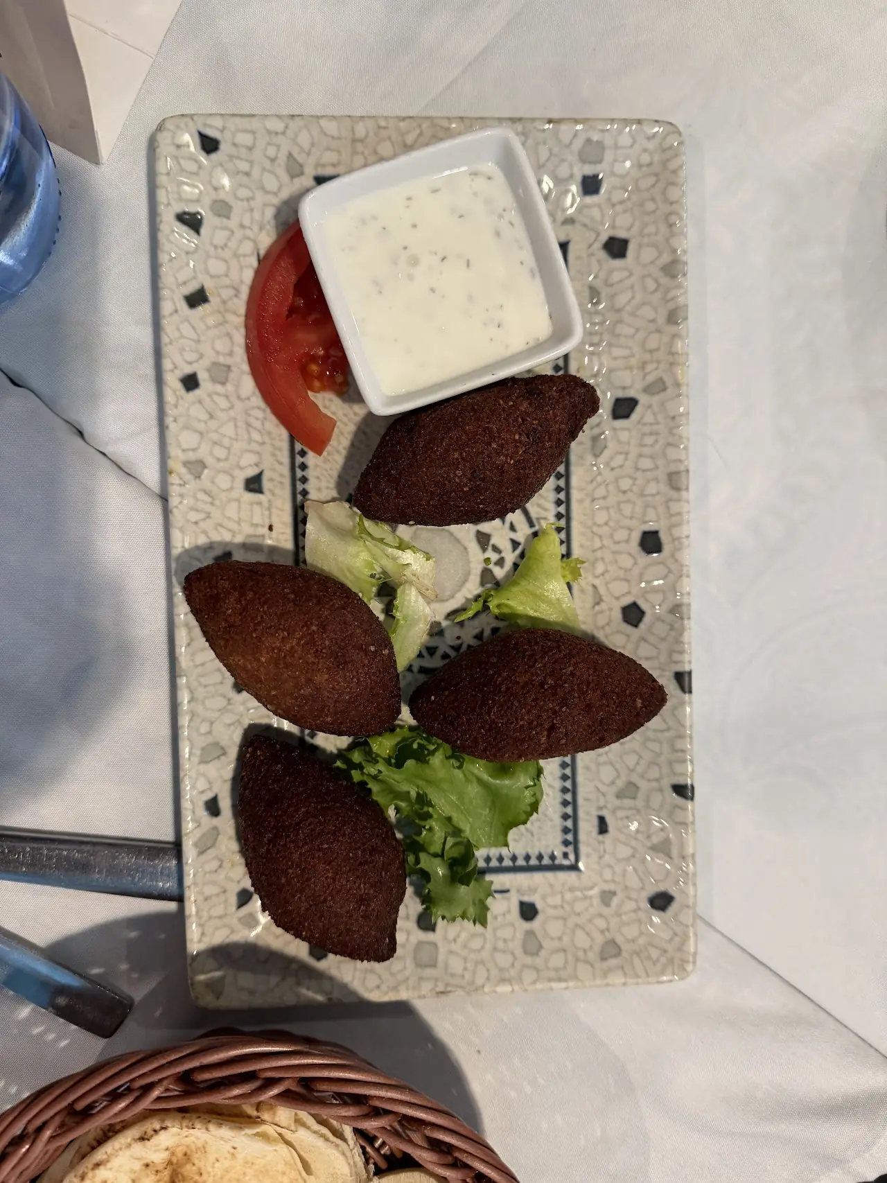 Fried croquette-style pieces with a yogurt dip and lettuce