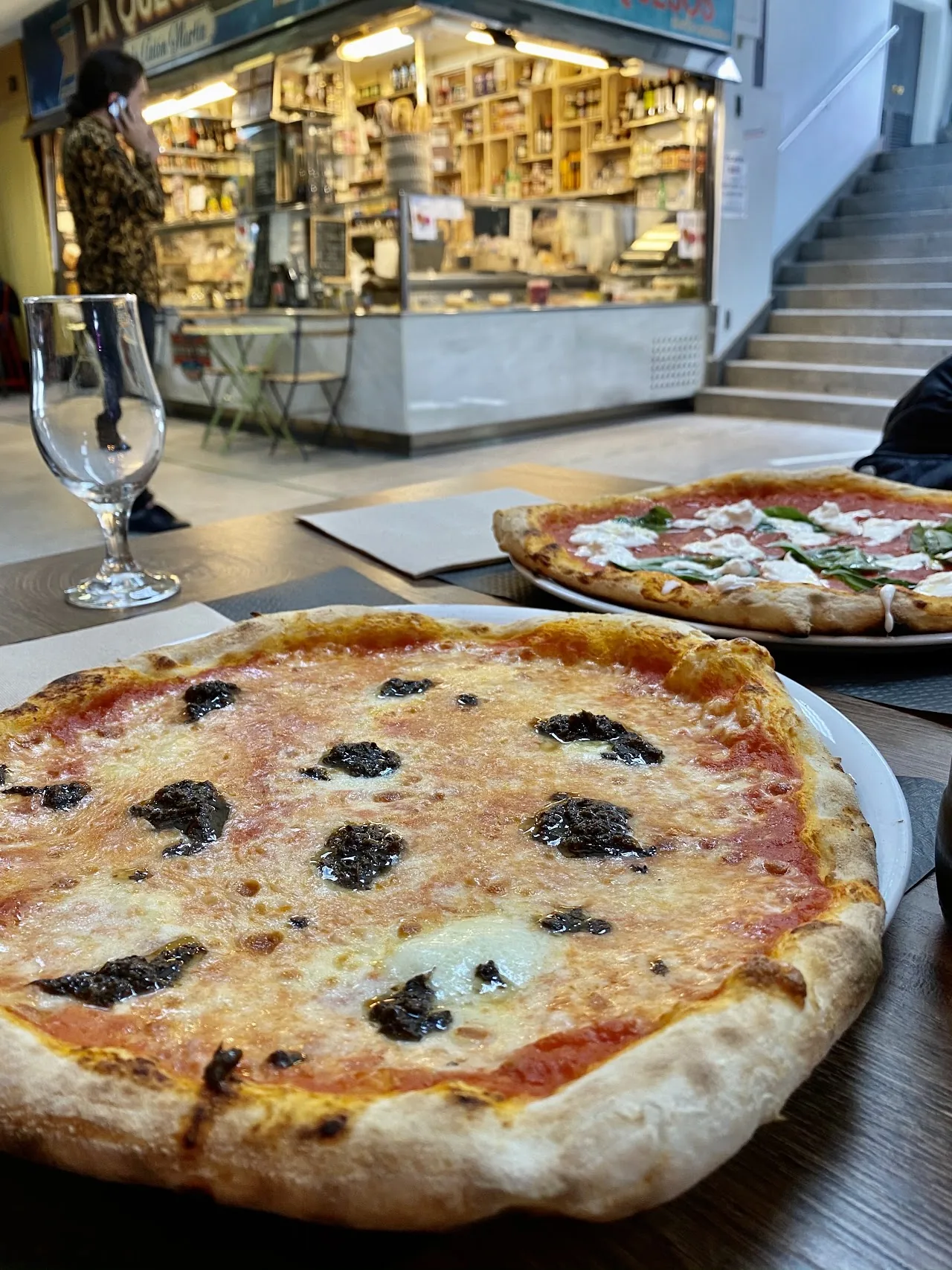 A pizza topped with black olives and melted cheese