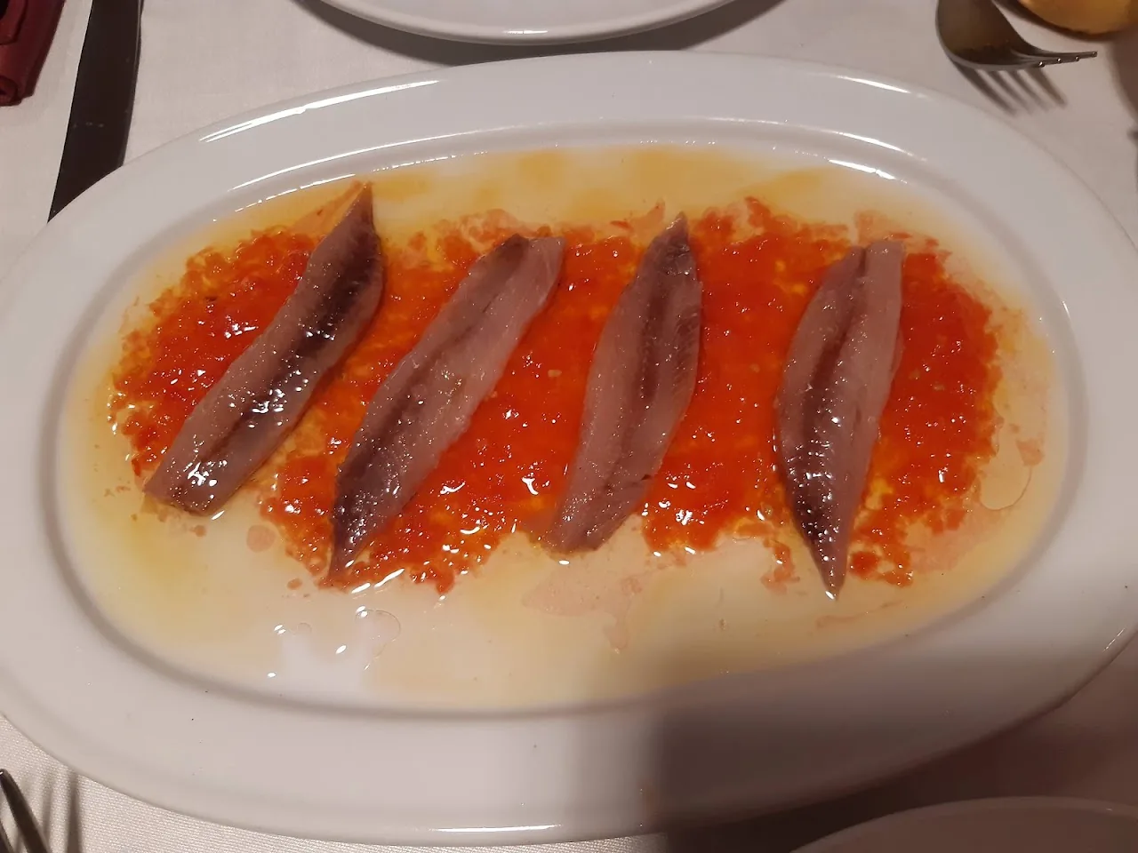 Anchovy fillets over roasted red pepper strips
