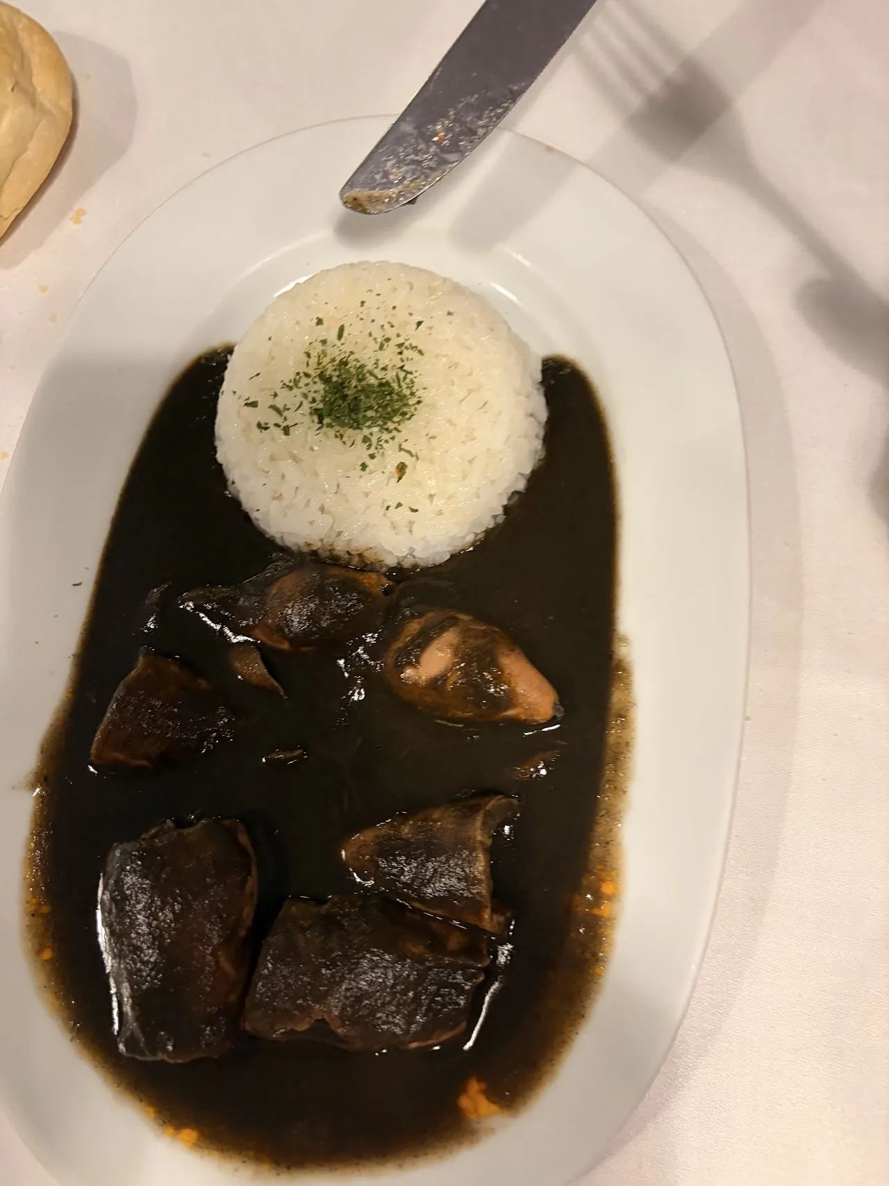 Squid simmered in its ink sauce served with white rice