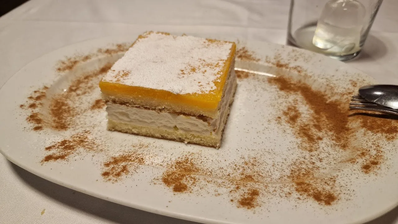 A slice of custard cake dusted with cinnamon