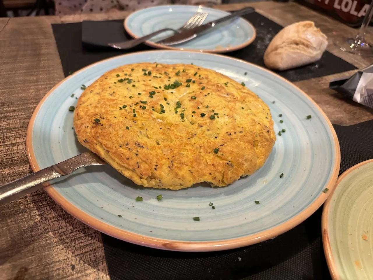 A round potato omelette on a plate