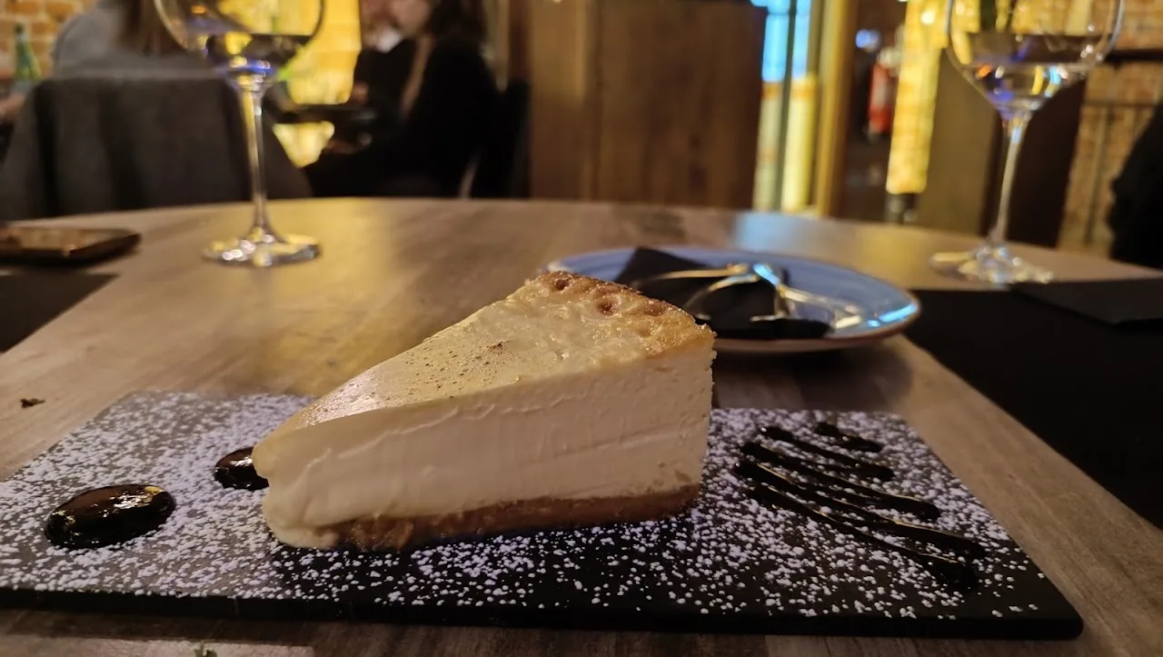 A slice of cheesecake with chocolate drizzle