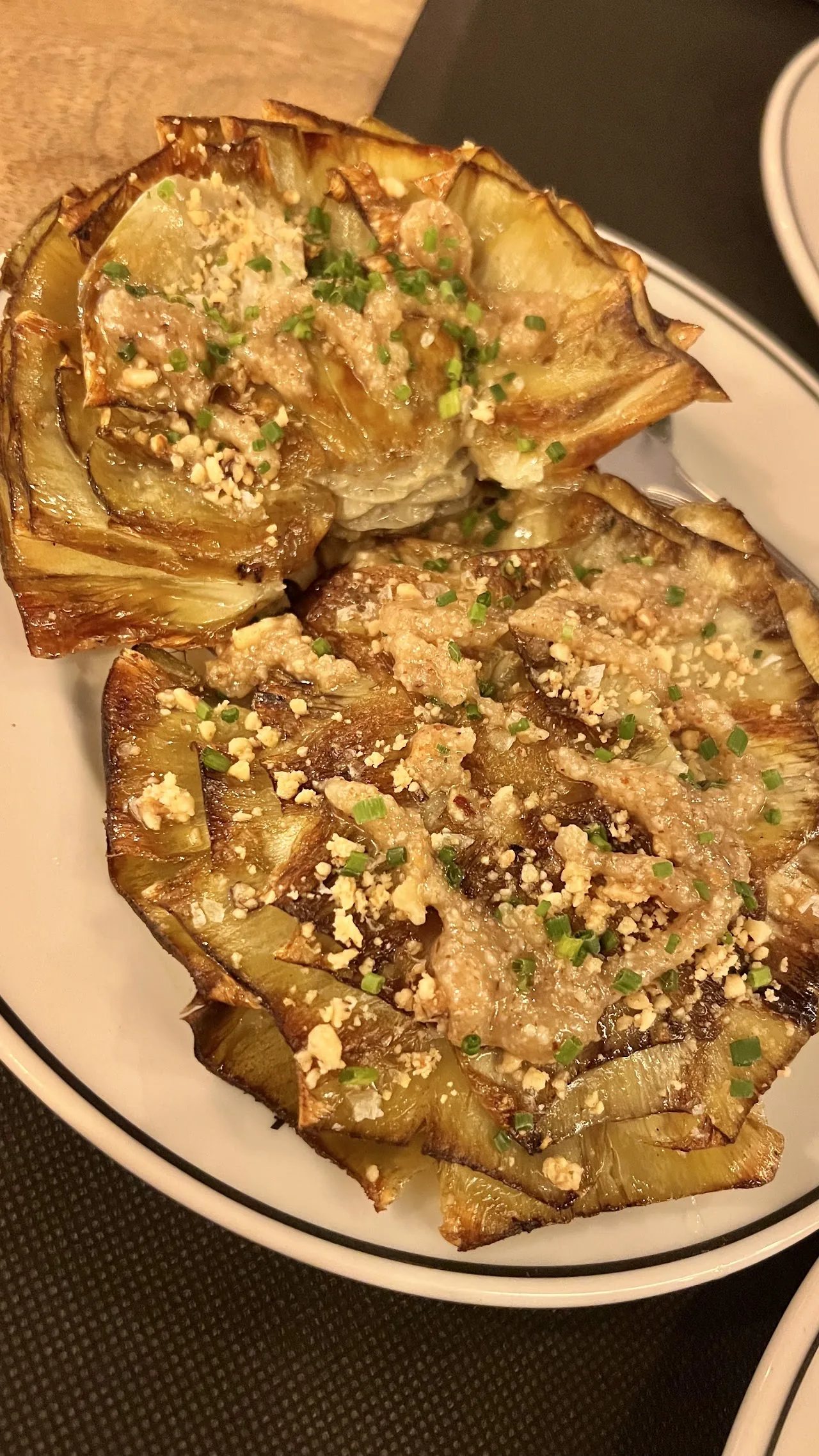 A flatbread tosta topped with garlic and herbs