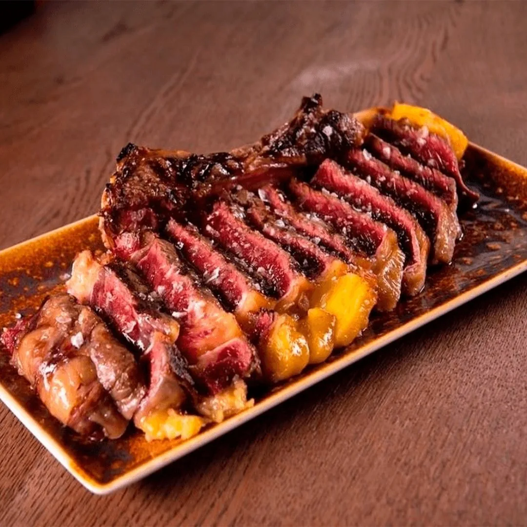 Sliced grilled steak on a rectangular plate