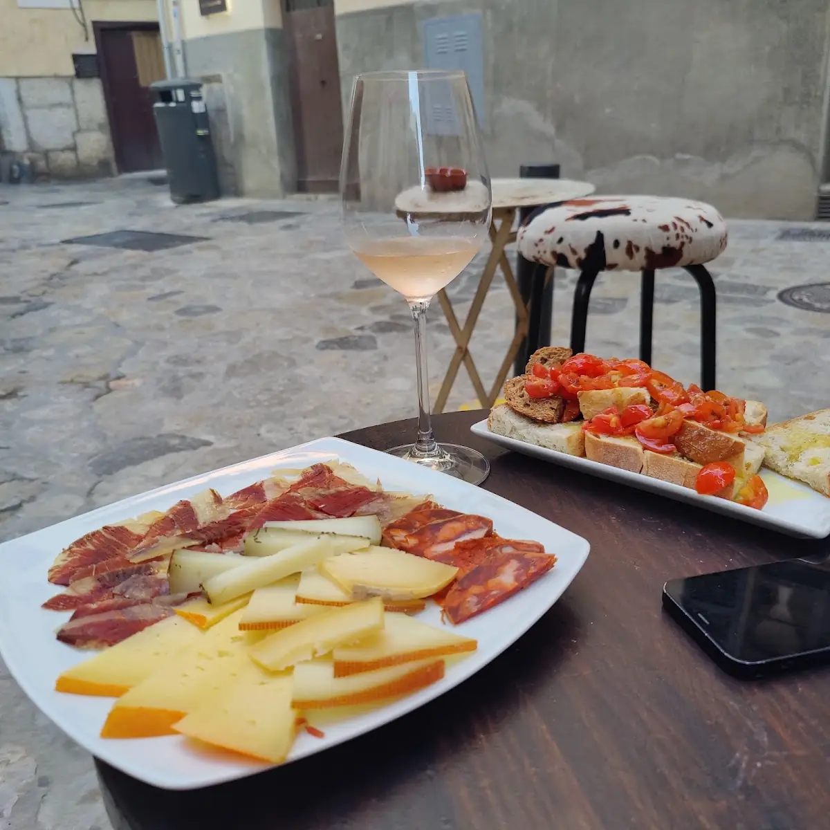 A cheese and charcuterie board with wine at La Vinya de Santa Clara