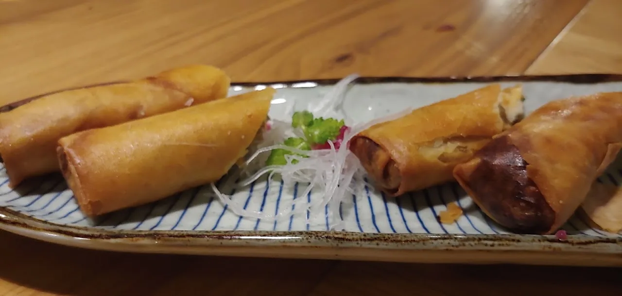 Three fried spring rolls on a plate
