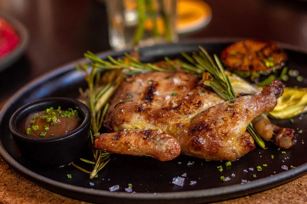A grilled chicken dish with rosemary and roasted garlic