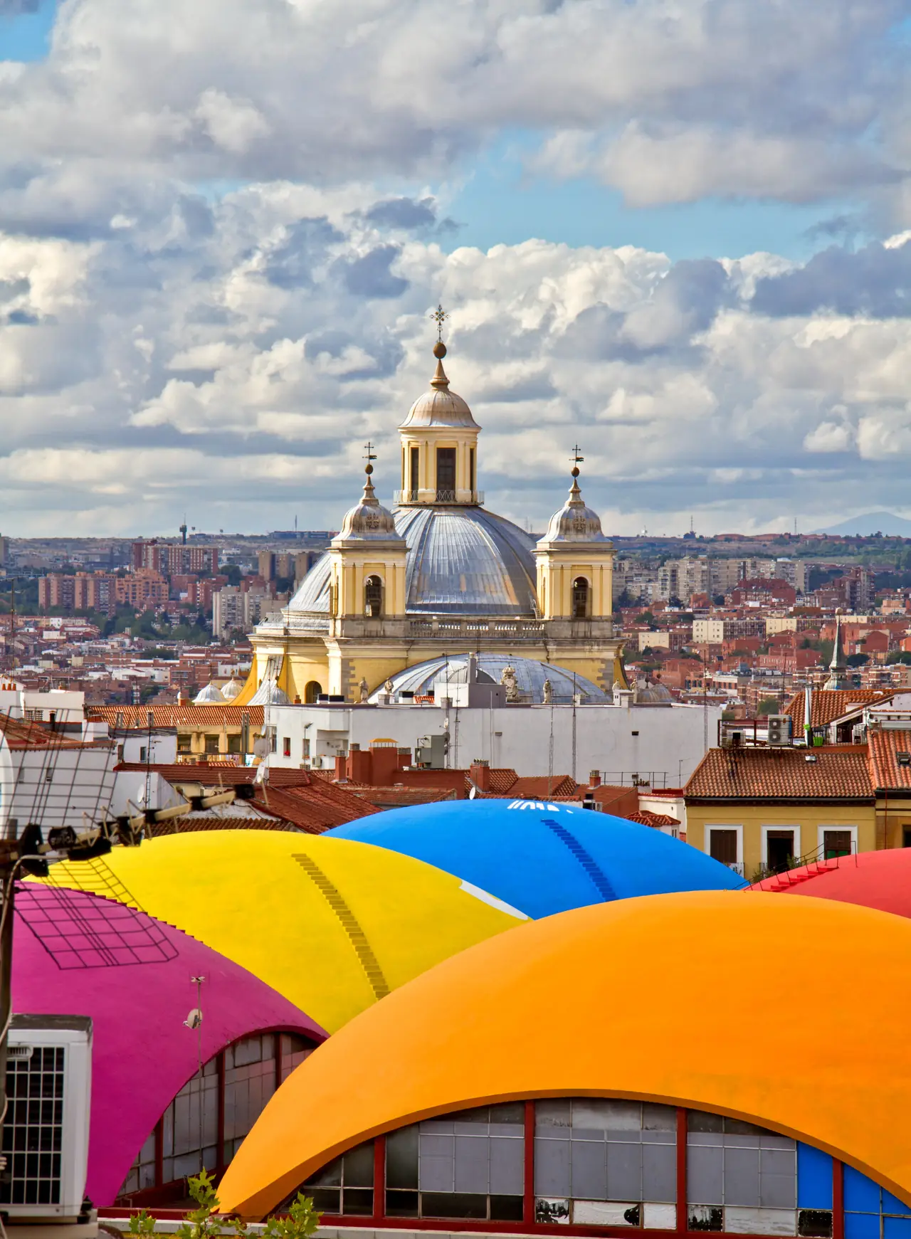 The domed Basilica de San Francisco el Grande rising over the colorful curved roofs of La Latina's rooftops