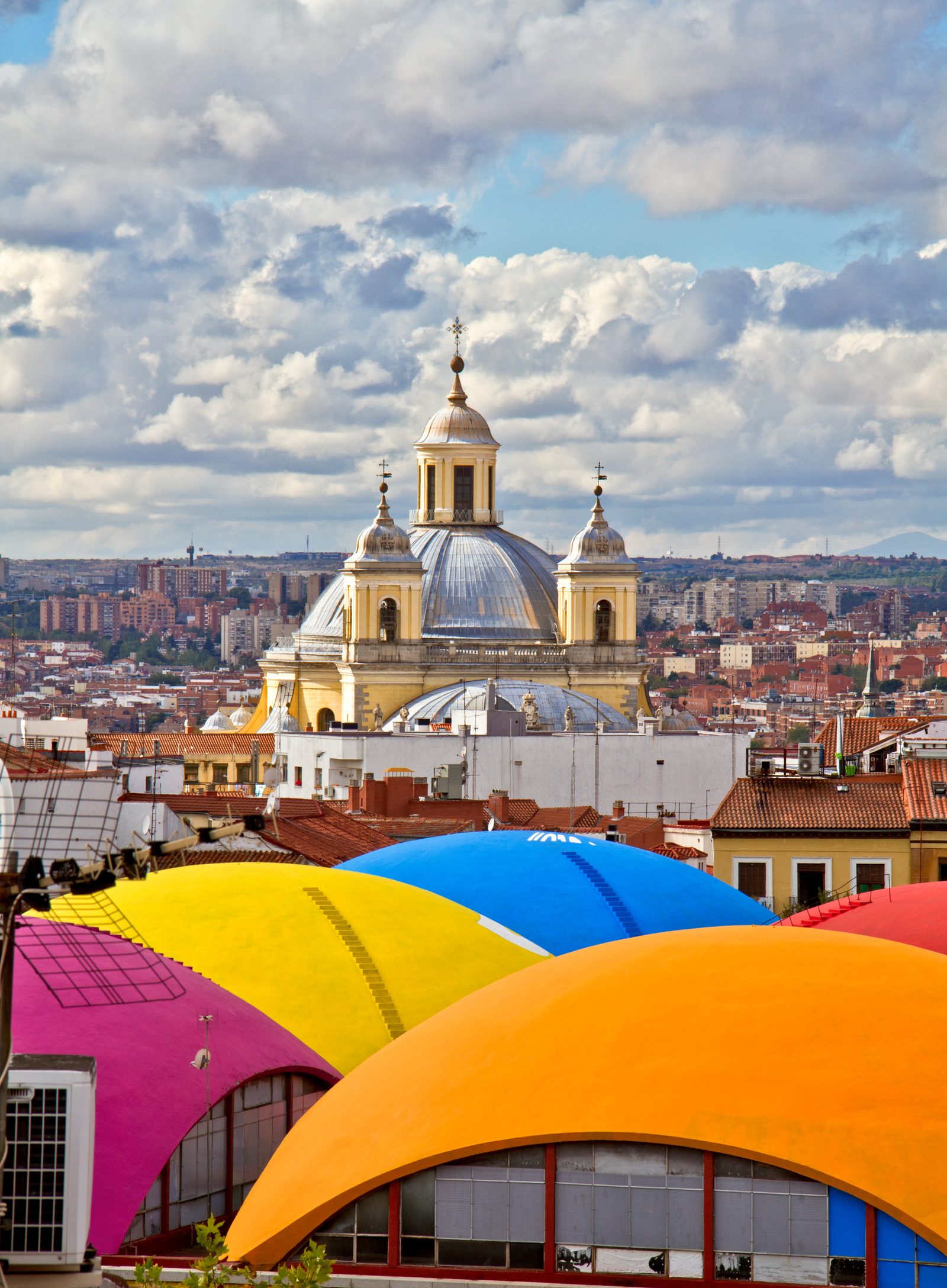 The domed Basilica de San Francisco el Grande rising over the colorful curved roofs of La Latina's rooftops