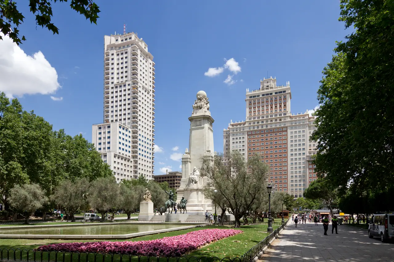The Torre de Madrid and Edificio España towers rising behind the Cervantes monument and its equestrian statues of Don Quixote and Sancho Panza