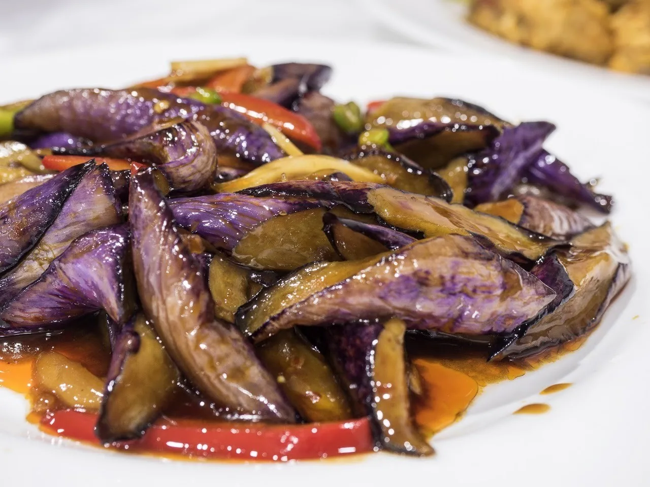 A plate of braised aubergine in sauce