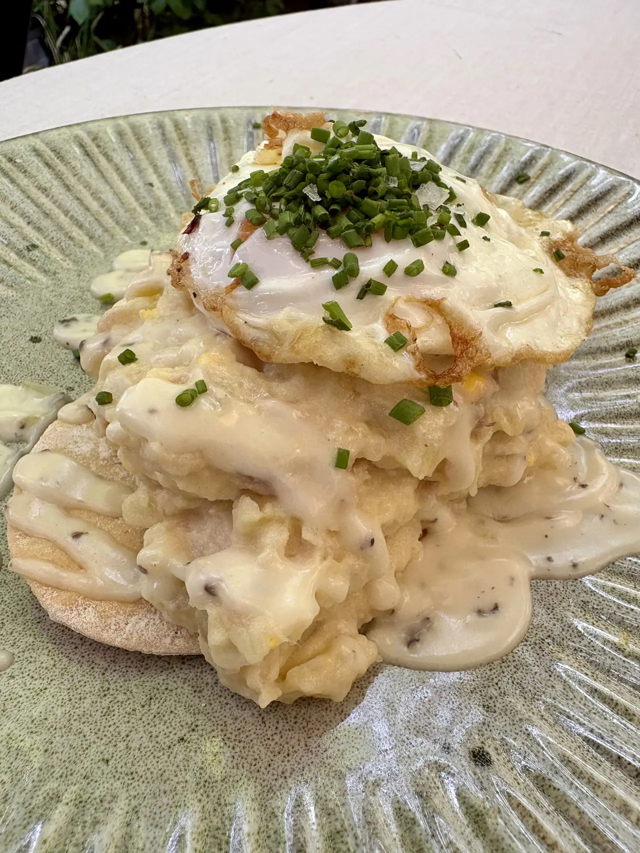 Fried egg with chives on top of creamy truffled potato stack