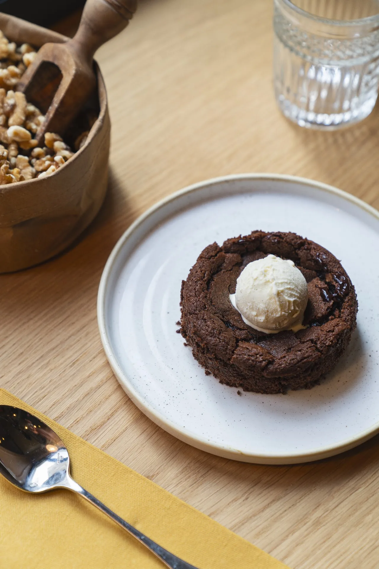 A chocolate dessert topped with a scoop of ice cream