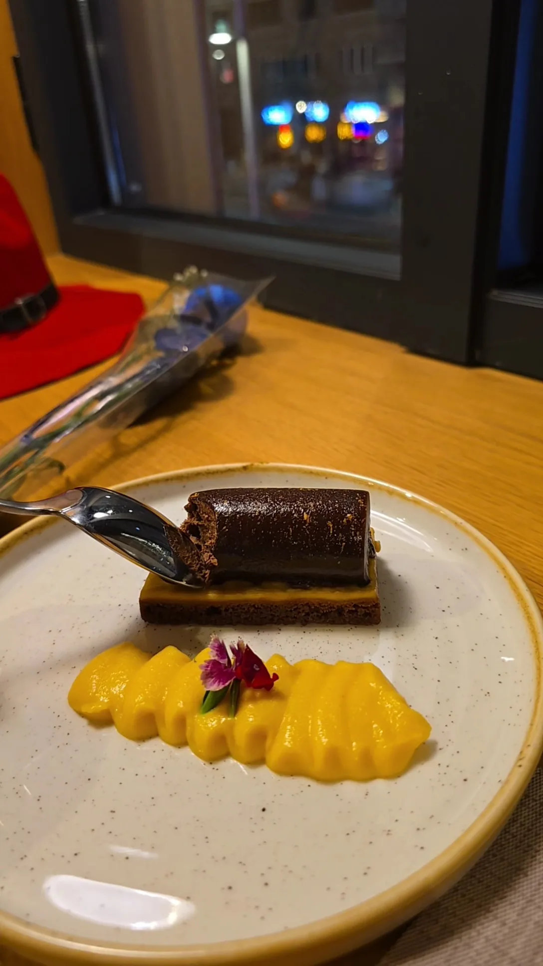 A slice of layered chocolate cake with a pineapple garnish