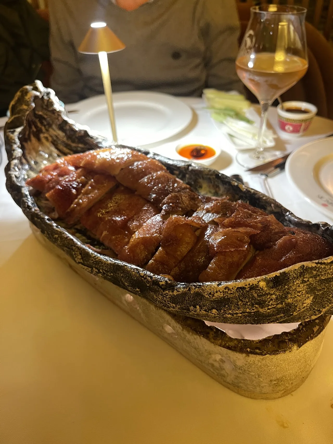 Sliced roast meat served in a boat-shaped dish